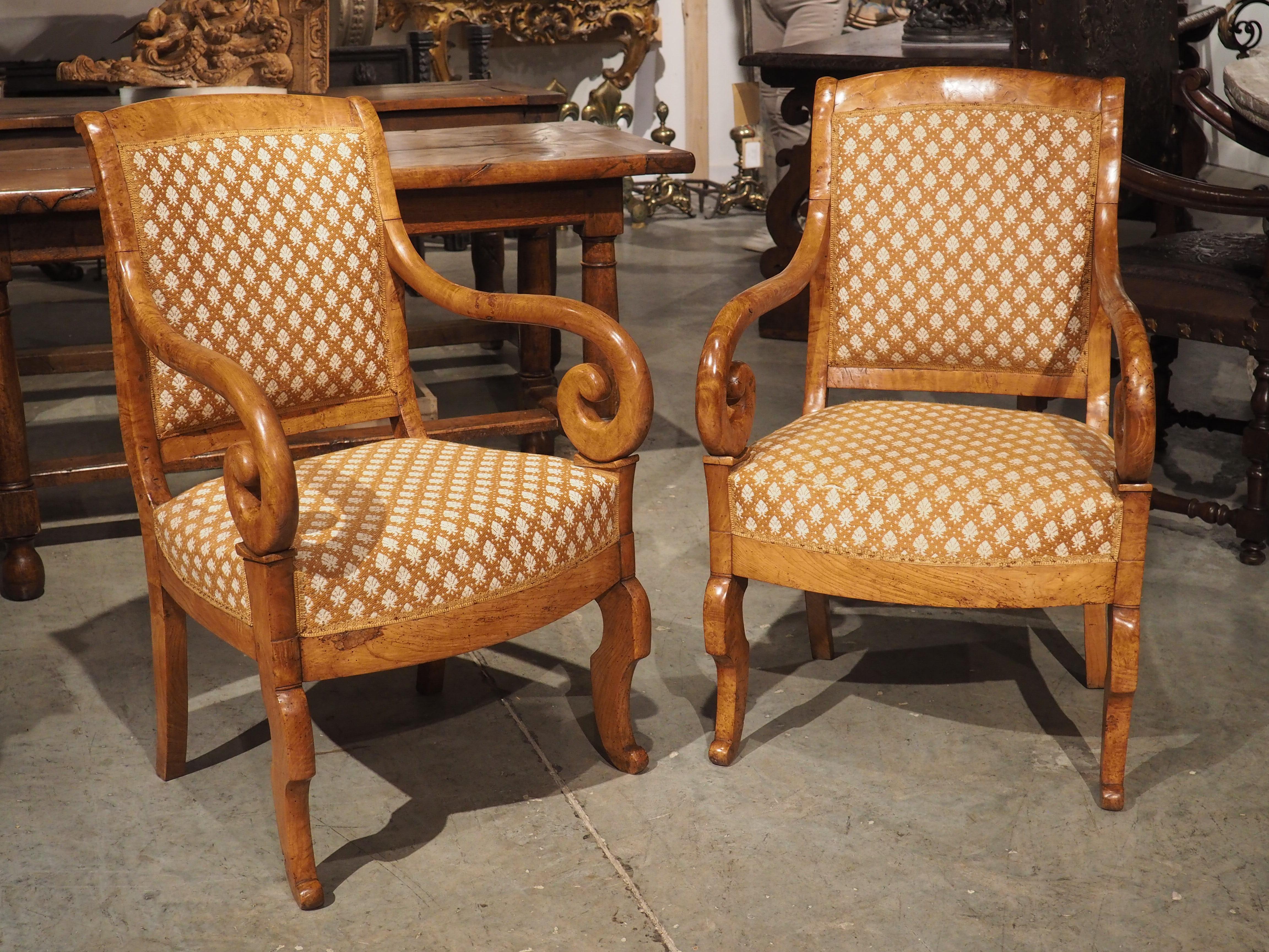 Known as pied en cuisse de grenouille, or “frog leg foot”, this pair of elmwood armchairs has interesting front legs formed by counter curves. Hand-carved in France, circa 1840, the armchairs are Louis Philippe, the period in which these motifs were
