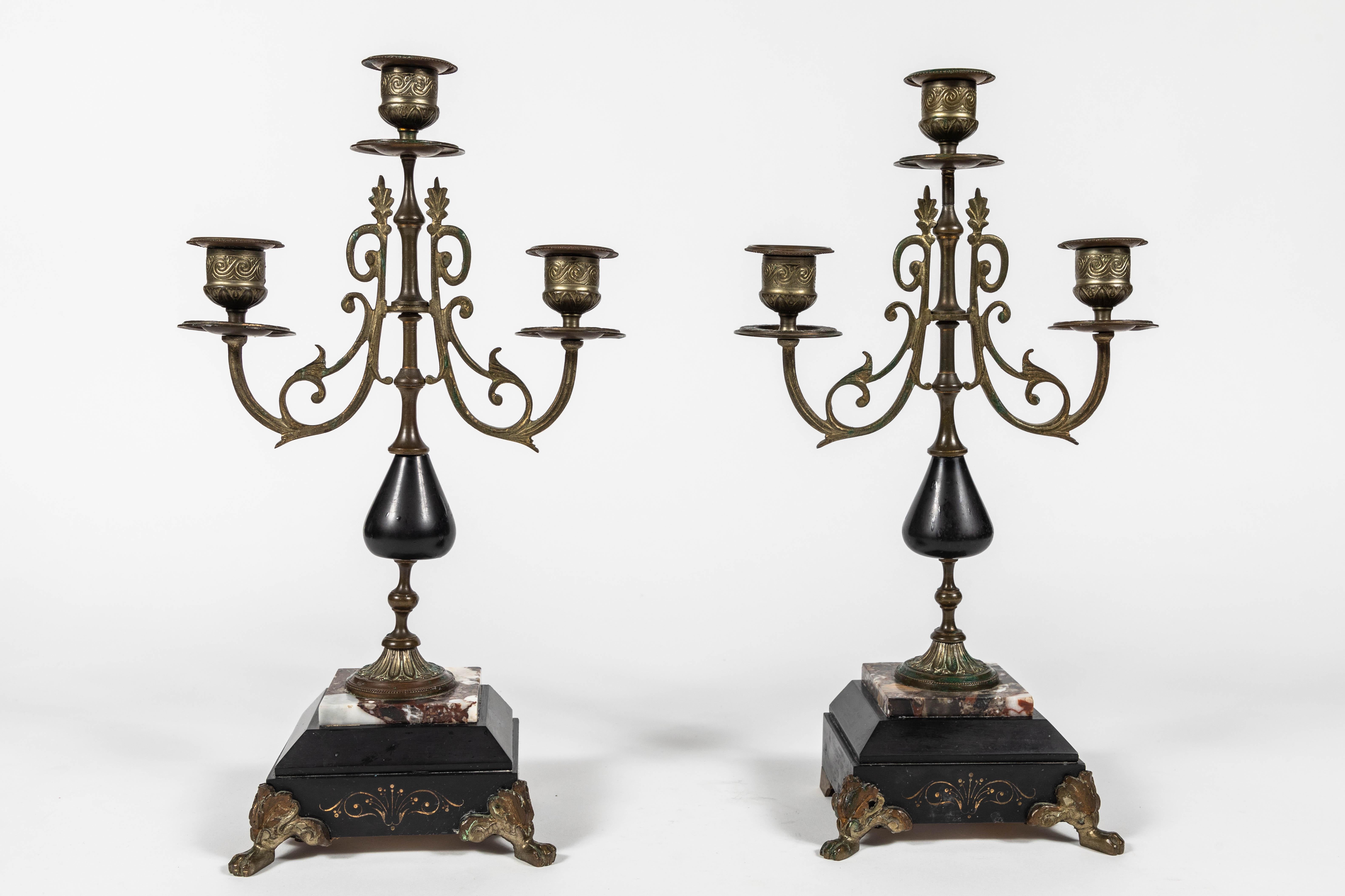 Pair of antique French Empire style marble and brass candelabras.