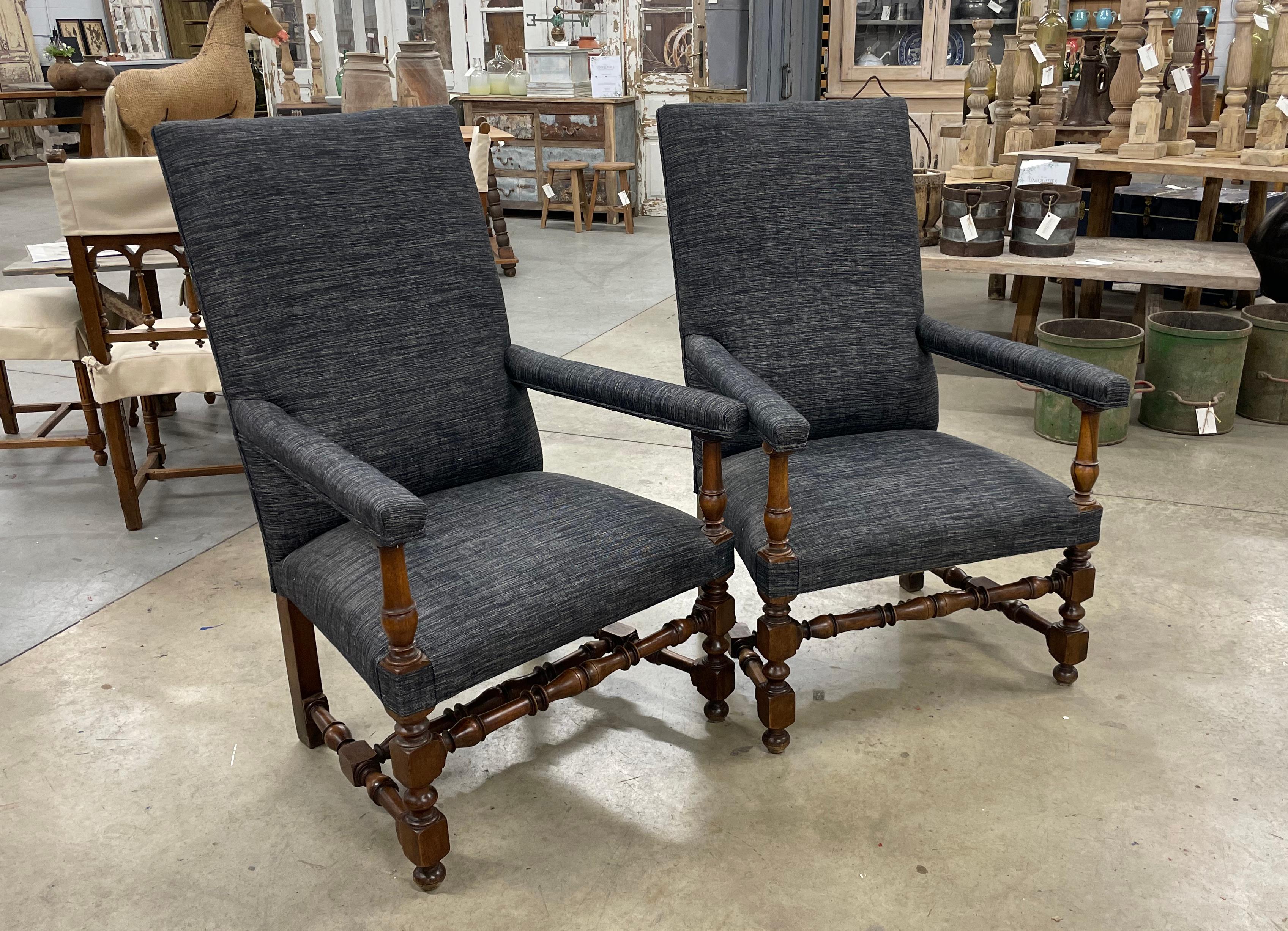 Substantial pair of 19th century Louis XIII style carved walnut French fauteuil armchairs. The chairs have block and turned front legs connected by a centre turned stretcher with turned sides that connect to straight back legs.

The chairs are