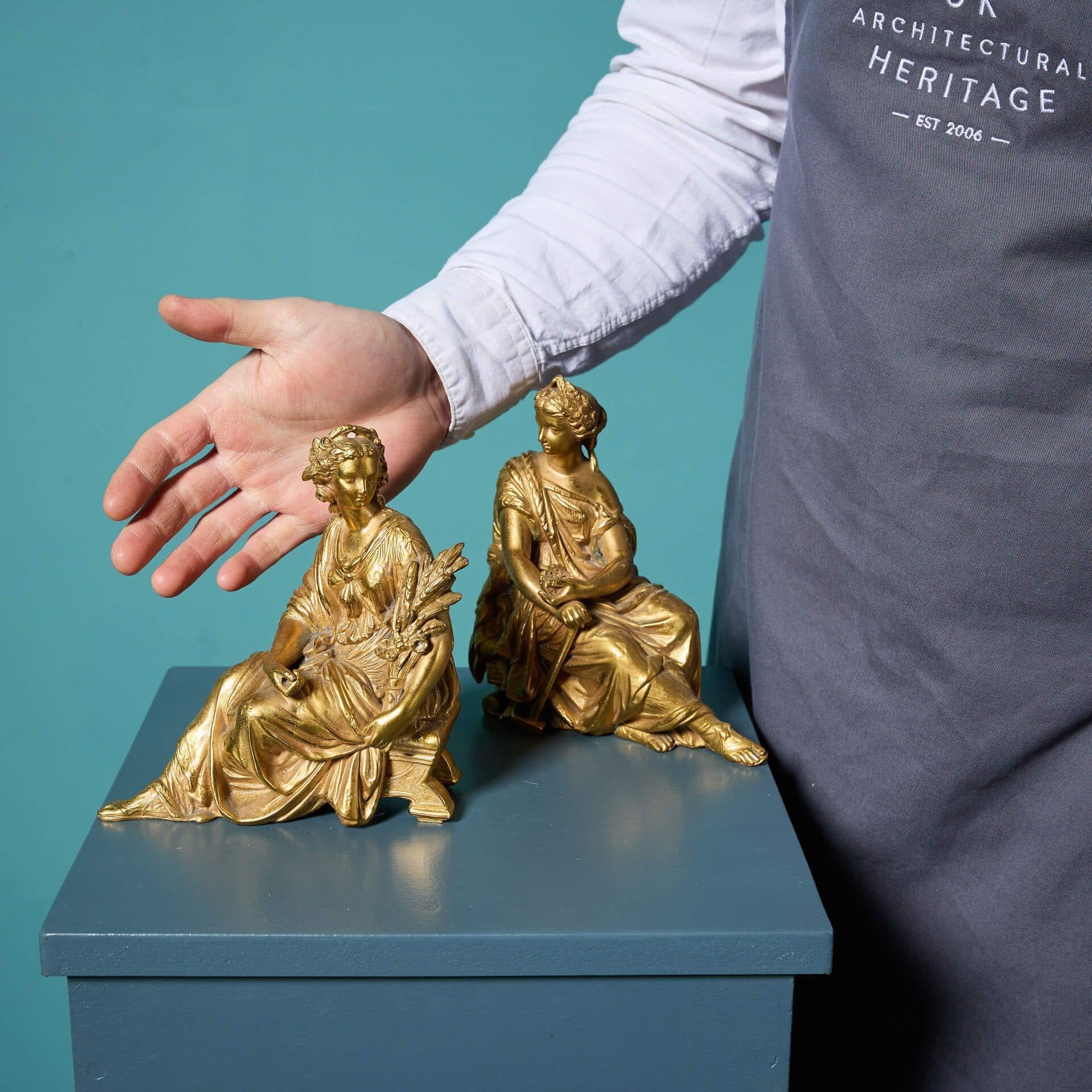 Two elegant antique French gilded neoclassical spelter figures dating to circa 1880.

This decorative pair of classical sculptures – one modelled as a seated female holding a wheat sheaf, emblematic of agriculture, and the other as another seated
