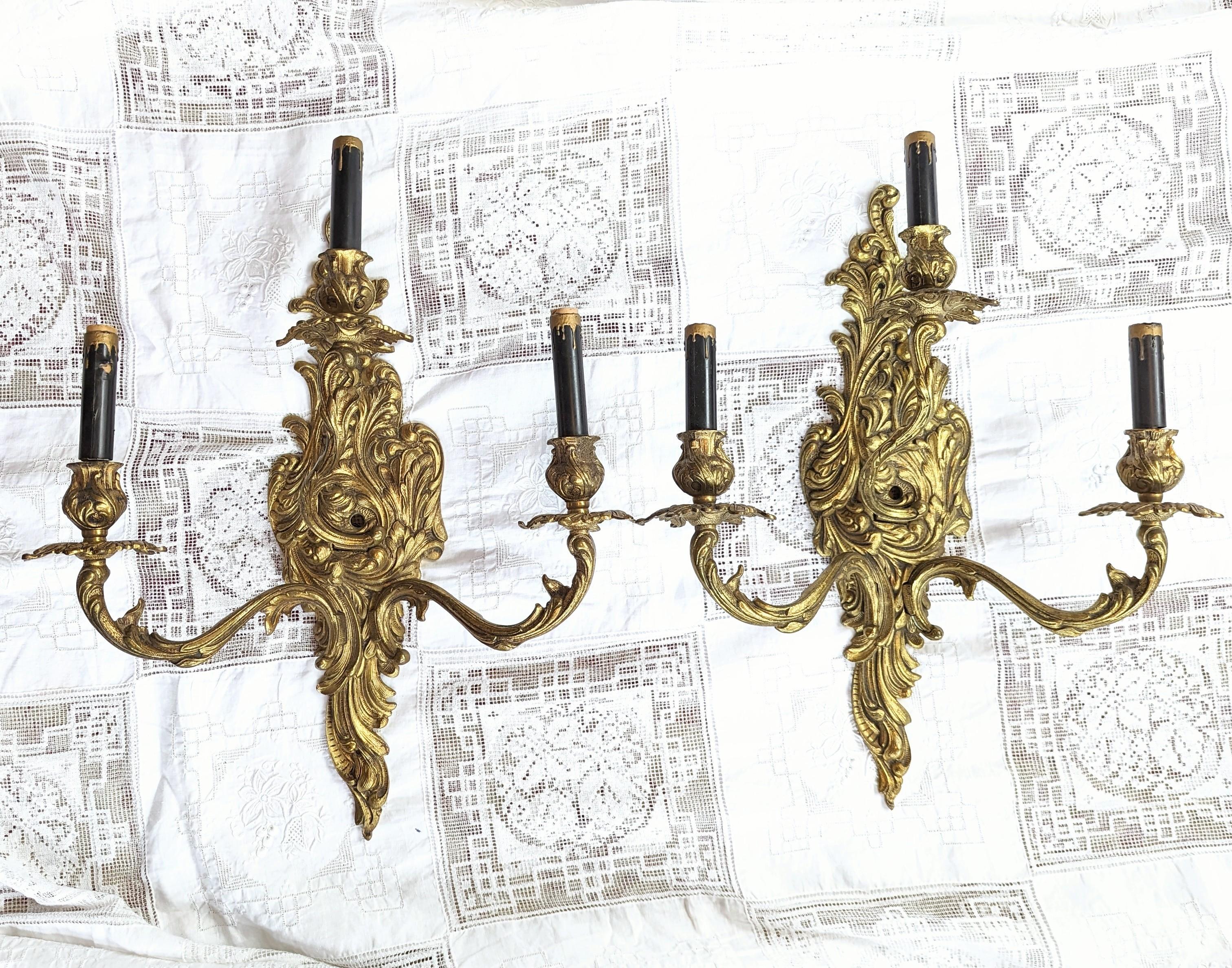 Pair of Magnificent Antique French Gilded Sconces. Measures 19 inches from top to bottom, the arms extend to approximately 16.5 inches in width, the interior portion is 5 inches in width, and they extend approximately 6.5 inches out from the wall.