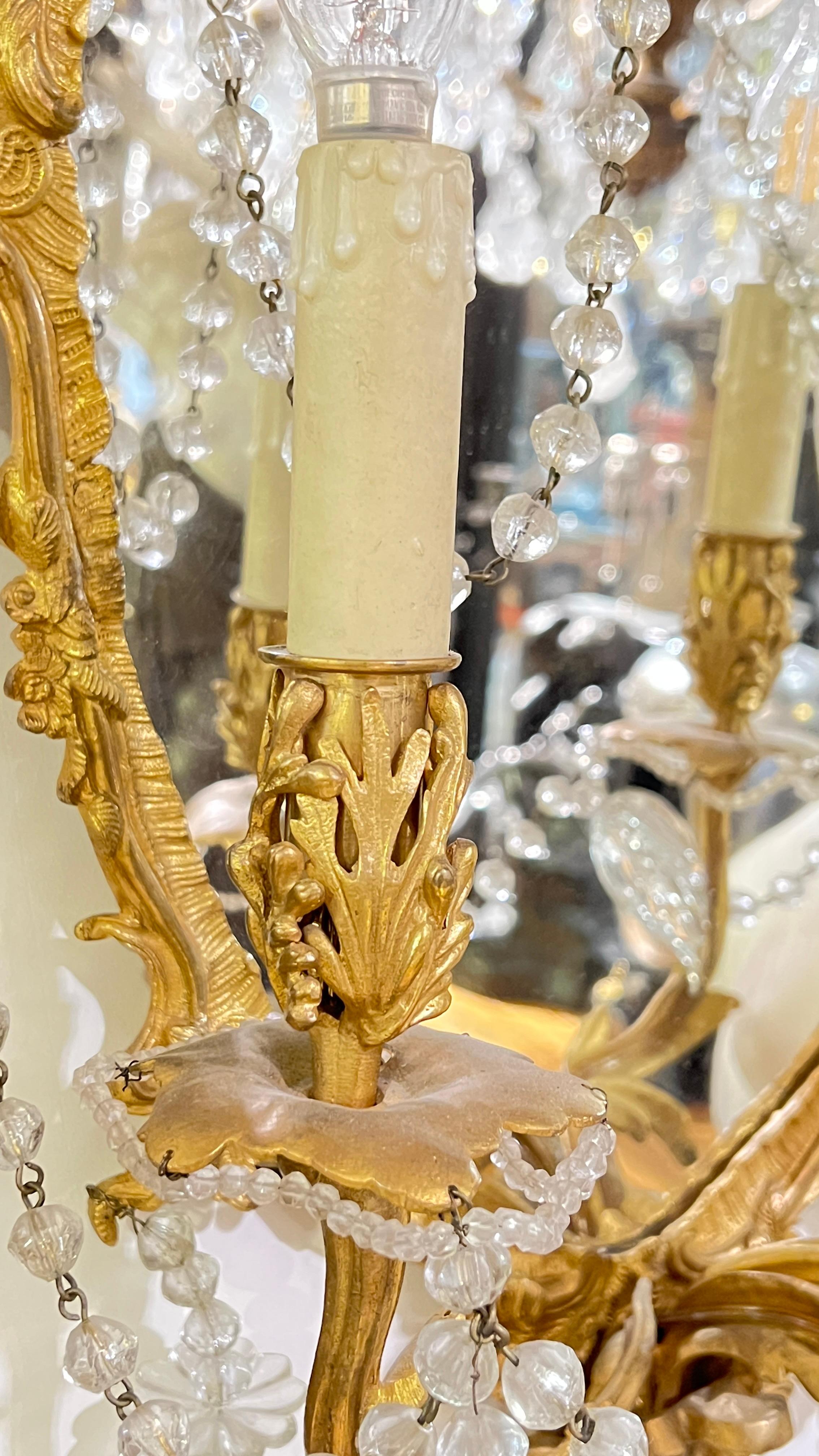 Crystal Pair of antique French  Gilt Bronze Mirrored Three-Light Sconces For Sale