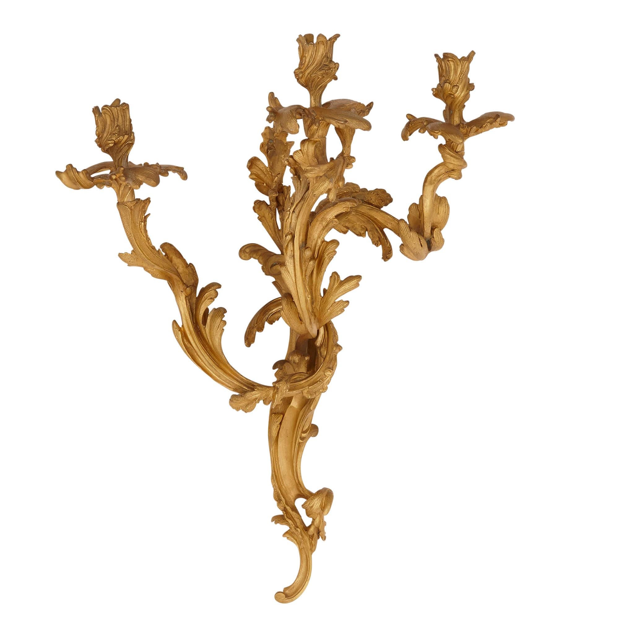 Pair of antique French gilt bronze sconces in the Baroque style
French, late 19th century
Measures: Height 61cm, width 39cm, depth 26cm

The sconces in this pair are wrought from gilt bronze in the Baroque manner. Each sconce features three