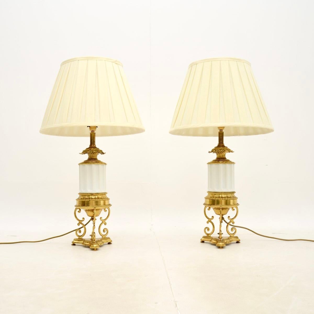 A fabulous pair of antique French gilt metal and ceramic table lamps, dating from around the 1900-1920 period.

They are lovely quality and have a gorgeous design. The gilt metal has intricate and beautiful details, with cylindrical fluted ceramic