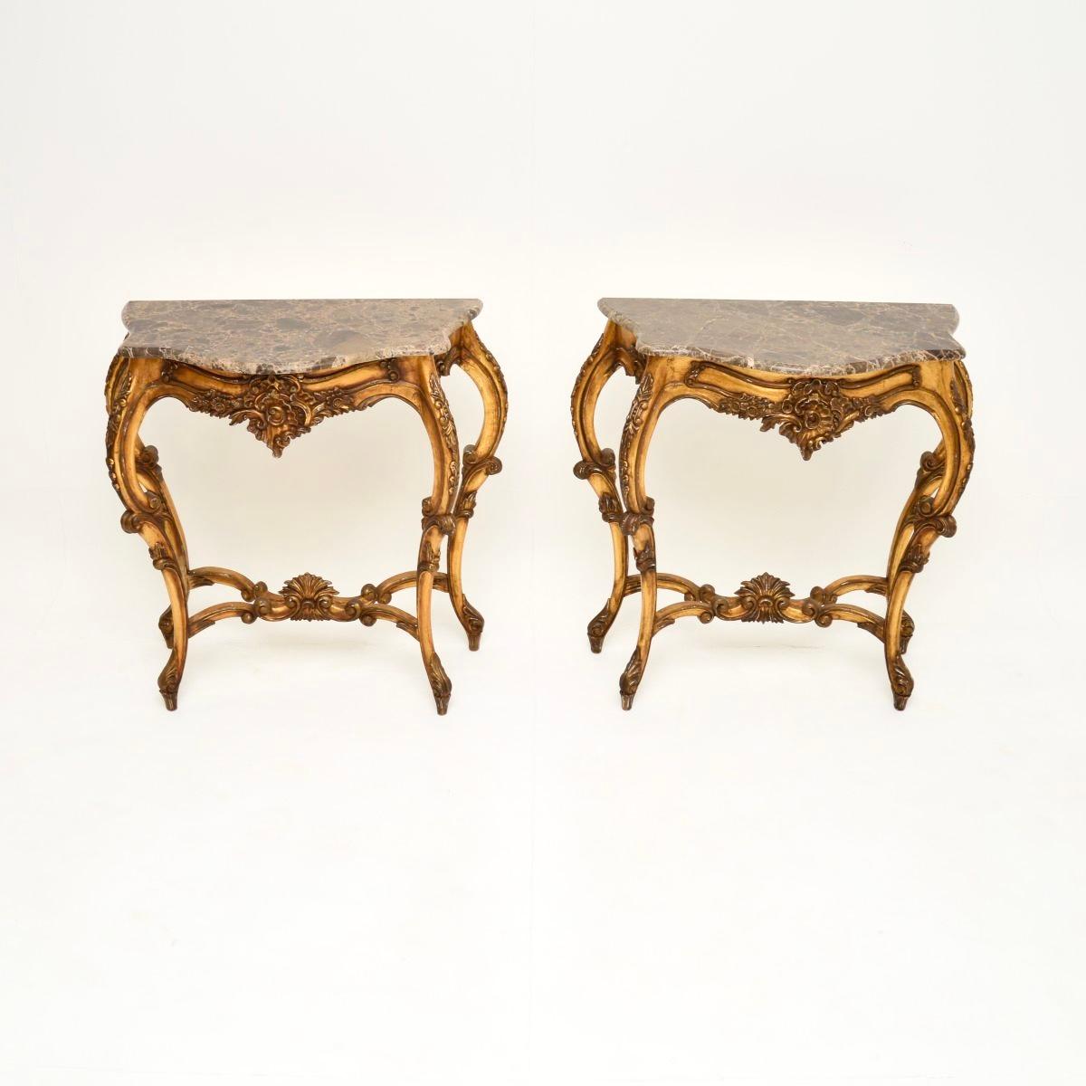 A stunning pair of antique French gilt wood marble top console tables, dating from around the 1950’s.

They are beautifully designed in the rococo fashion, the quality is superb. The frames are solid wood, they have gorgeous marble tops that sit