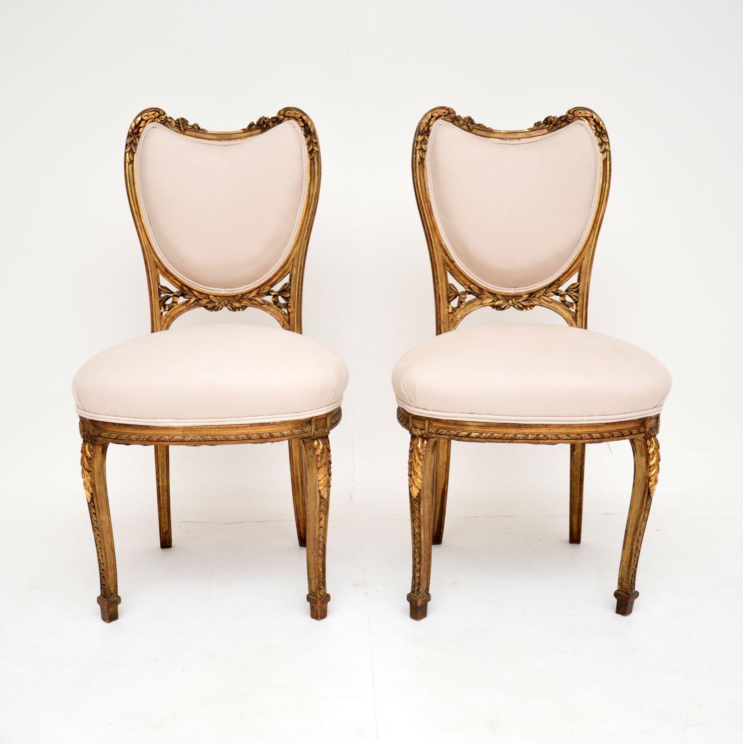 A stunning pair of original antique French carved gilt wood side chairs, dating from around the 1890-1900 period.

The quality is superb, they are beautifully made and have a gorgeous design. The backs have an interesting heart shape, there is
