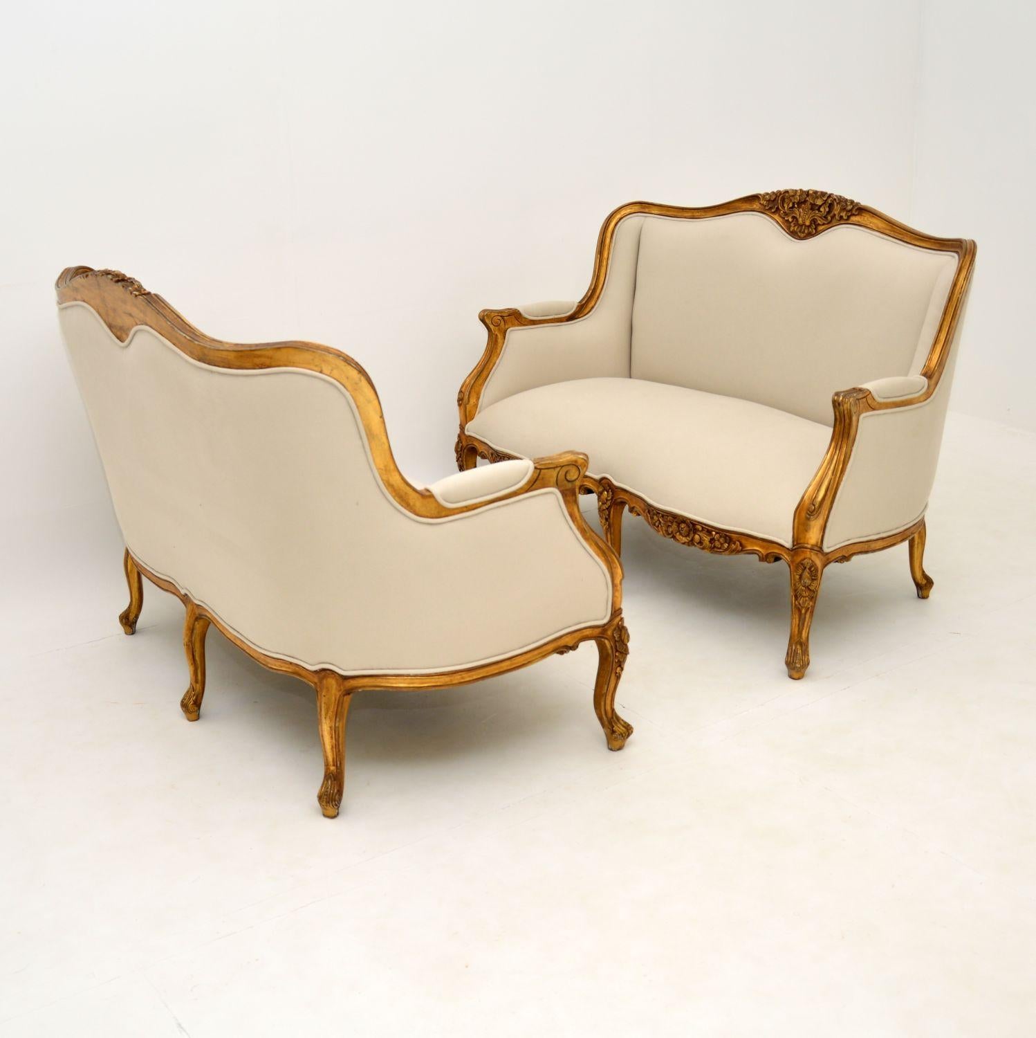 A stunning and top quality pair of two seater sofas in the antique French style which I would date from around the 1950’s period.

They are beautifully made, with a gorgeous shape and beautiful carving. They gilt wood frames have some minor wear