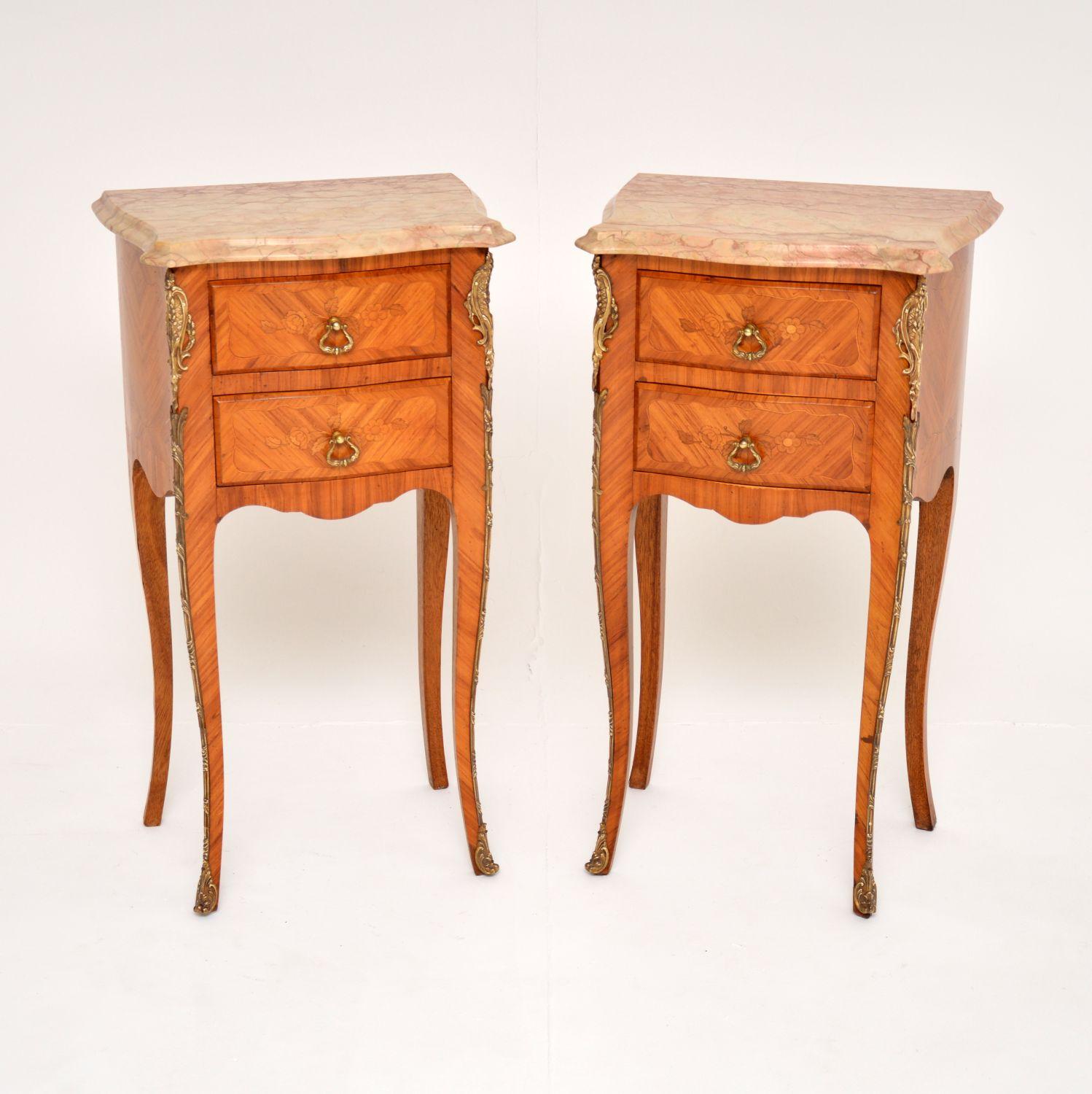 A beautiful pair of antique French bedside chests with marble tops, dating from around the 1920-30’s period.

They are of excellent quality & they have stunning inlaid marquetry of various woods. The marble tops have absolutely gorgeous colours
