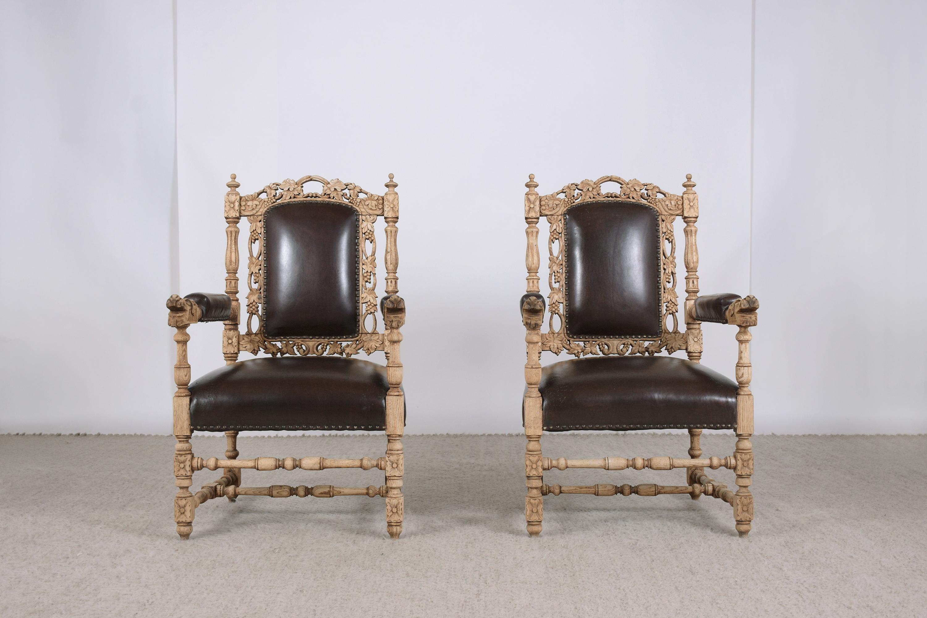 An extraordinary pair of antique french carved leather armchairs in great condition and professionally restored by our expert craftsmen team. These pieces are eye-catching beautifully crafted out of solid oak wood newly bleached, feature hand-carved