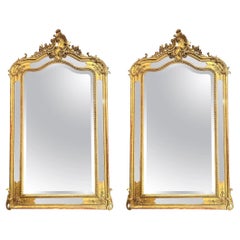 Pair of Antique French Louis XV Carved Wood and Gold Leaf Mirrors, circa 1890.