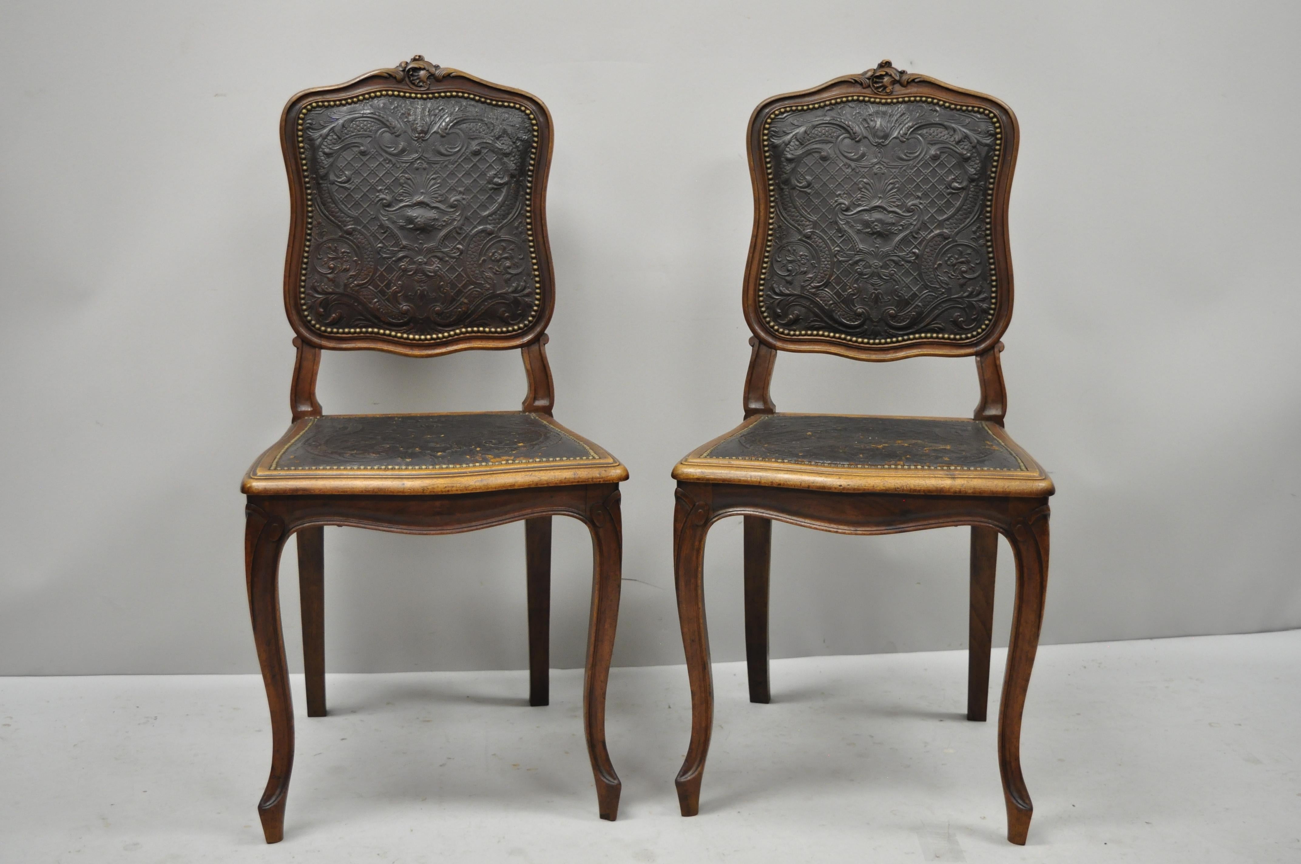 Pair of antique French Louis XV fancy brown embossed leather walnut side chair. Items feature brown embossed leather back and seat, nailhead trim, solid wood frame, finely carved details, cabriole legs, very nice antique item, great style and form,
