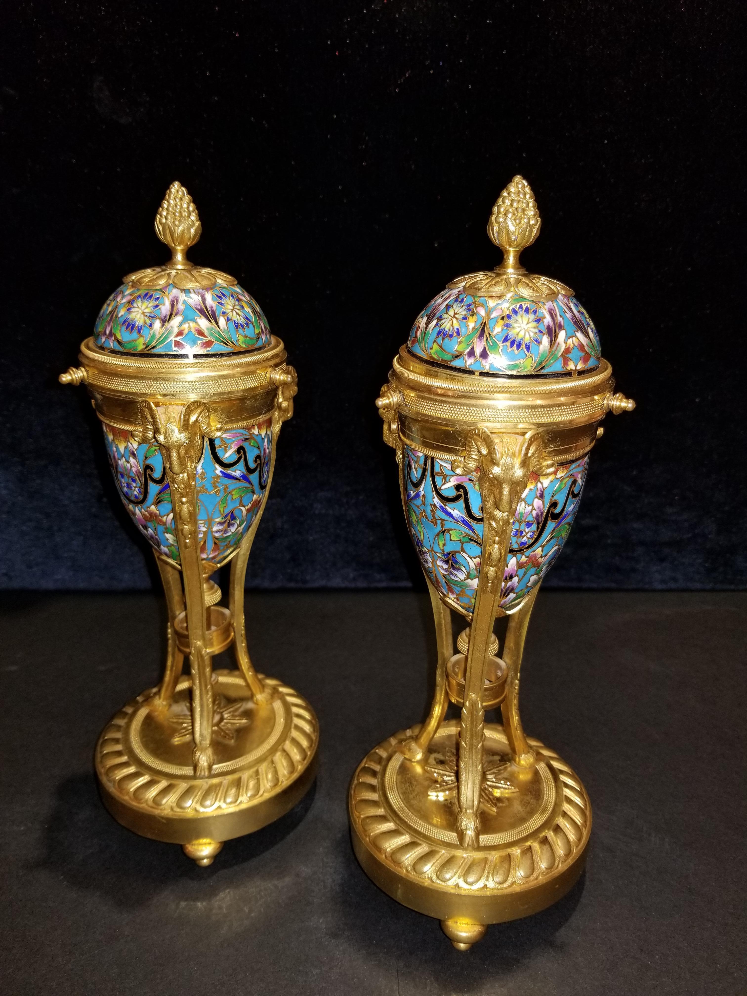 A fine pair of antique French cloisonné enamel and ormolu cassolettes. Cassolettes severed a duel purpose; they would be admired for their beauty during the day, and at night, the lids would be flipped and serve as candlesticks. This beautiful pair