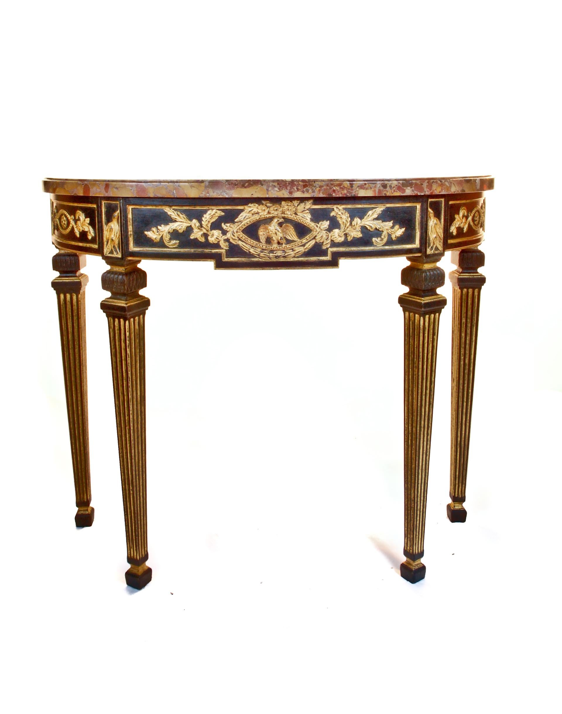 A pair of fine antique French Louis XVI style ebony and gilt decorated hand-carved wood marble top demilune shaped console tables embellished with eagles in the centre.