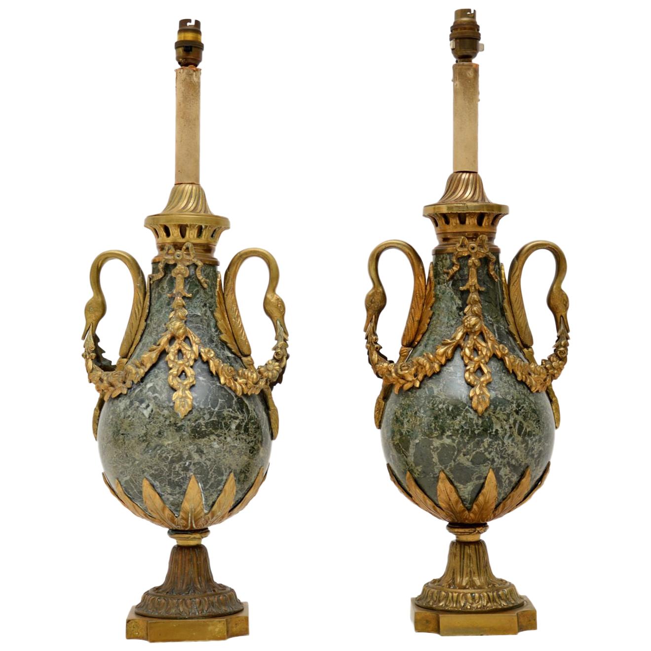 Very large impressive pair of French antique marble and gilt bronze table lamps in working order, because they have just been re-wired. They are in excellent condition and the gilt bronze is very finely detailed. Not sure of the exact age of these