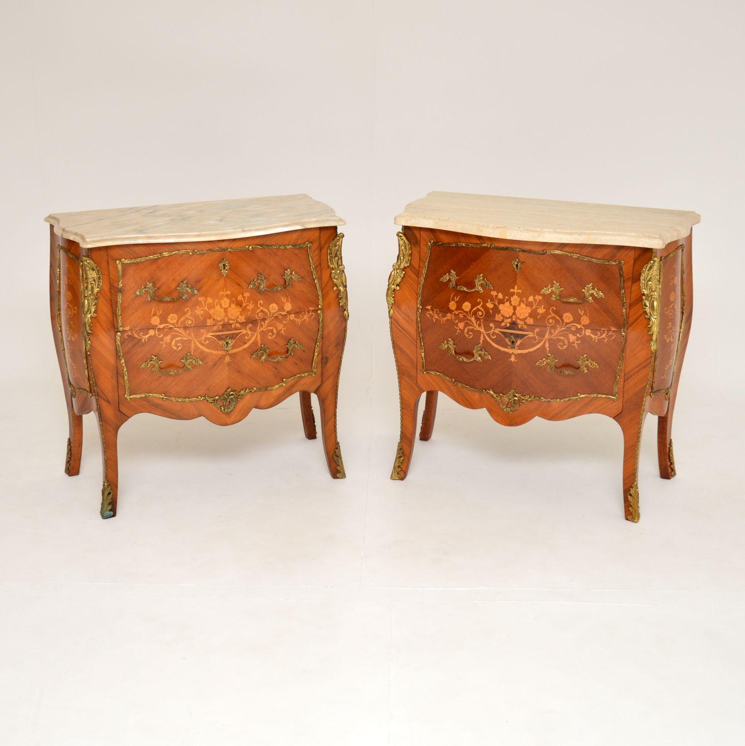 A beautiful pair of antique bombe shaped French marble top commodes, dating from around the 1930’s period.

They are of lovely quality and have stunning inlaid marquetry of various woods. There are superb decorative ormolu mounts throughout, and