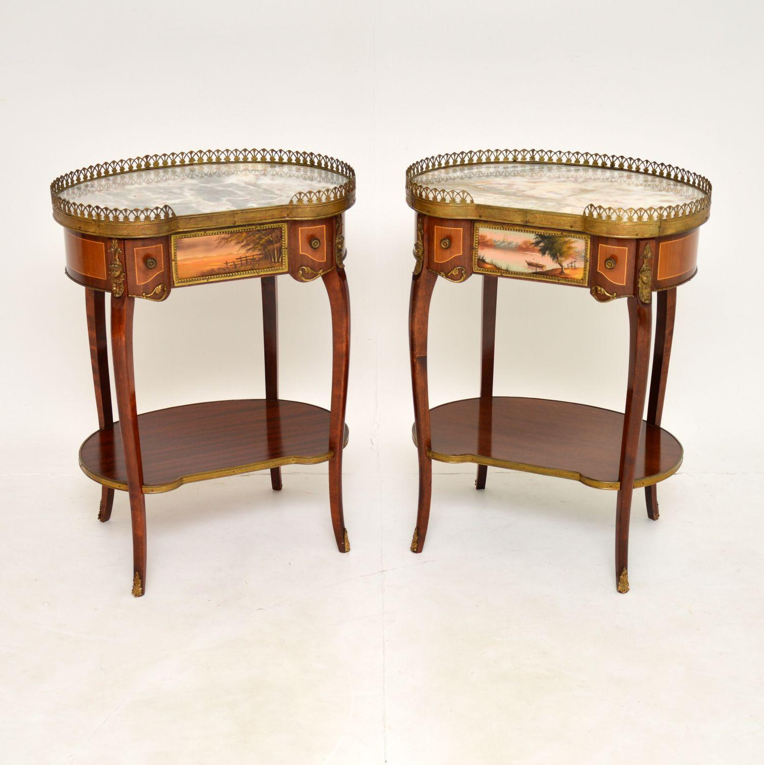 A stunning pair of antique French style kidney shaped side tables, dating from around the 1930’s period.

The quality is superb, with gorgeous marble tops and high quality gilt brass mounts throughout. They have beautifully painted plaques on the