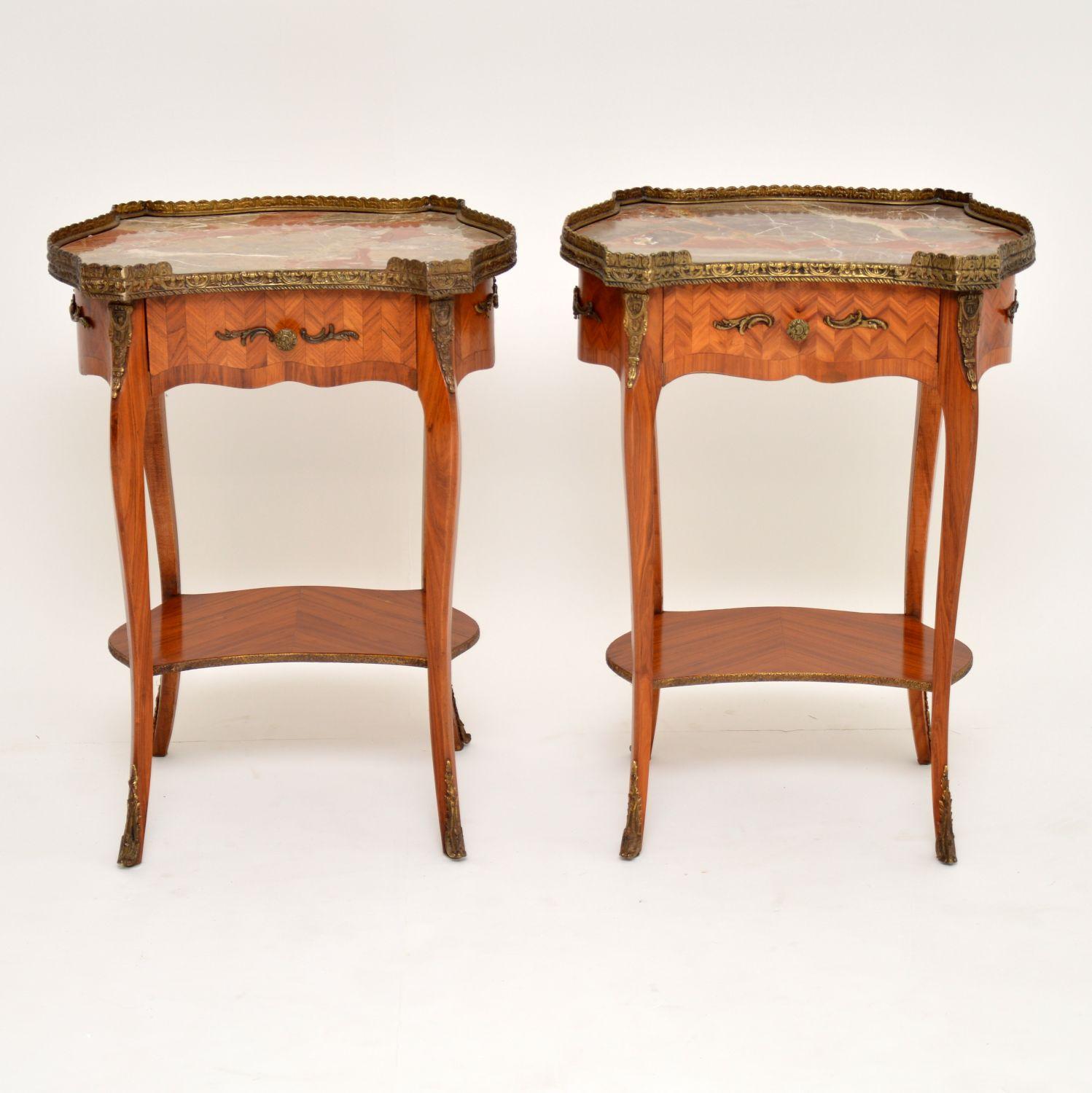 Pair of antique French style kingwood two-tiered side tables with colorful marble tops. These tables could have many uses in the home, like bedside tables, lamp tables, or end tables. I would date them to circa 1930s-1950s period & they have just