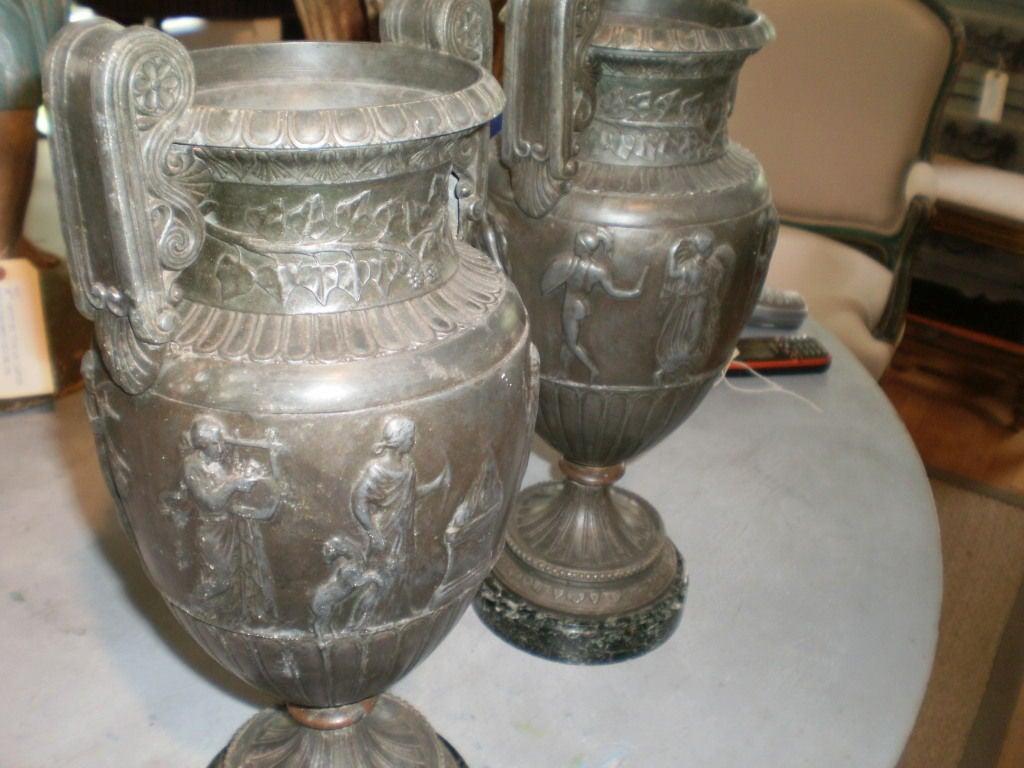 Pair of antique French Neoclassical style Urns.
Great pair of 19th century French Neoclassical style bronzed metal urns on marble bases. These stunning antique French Grecian style urns would look great on a console table, commode, credenza, buffet