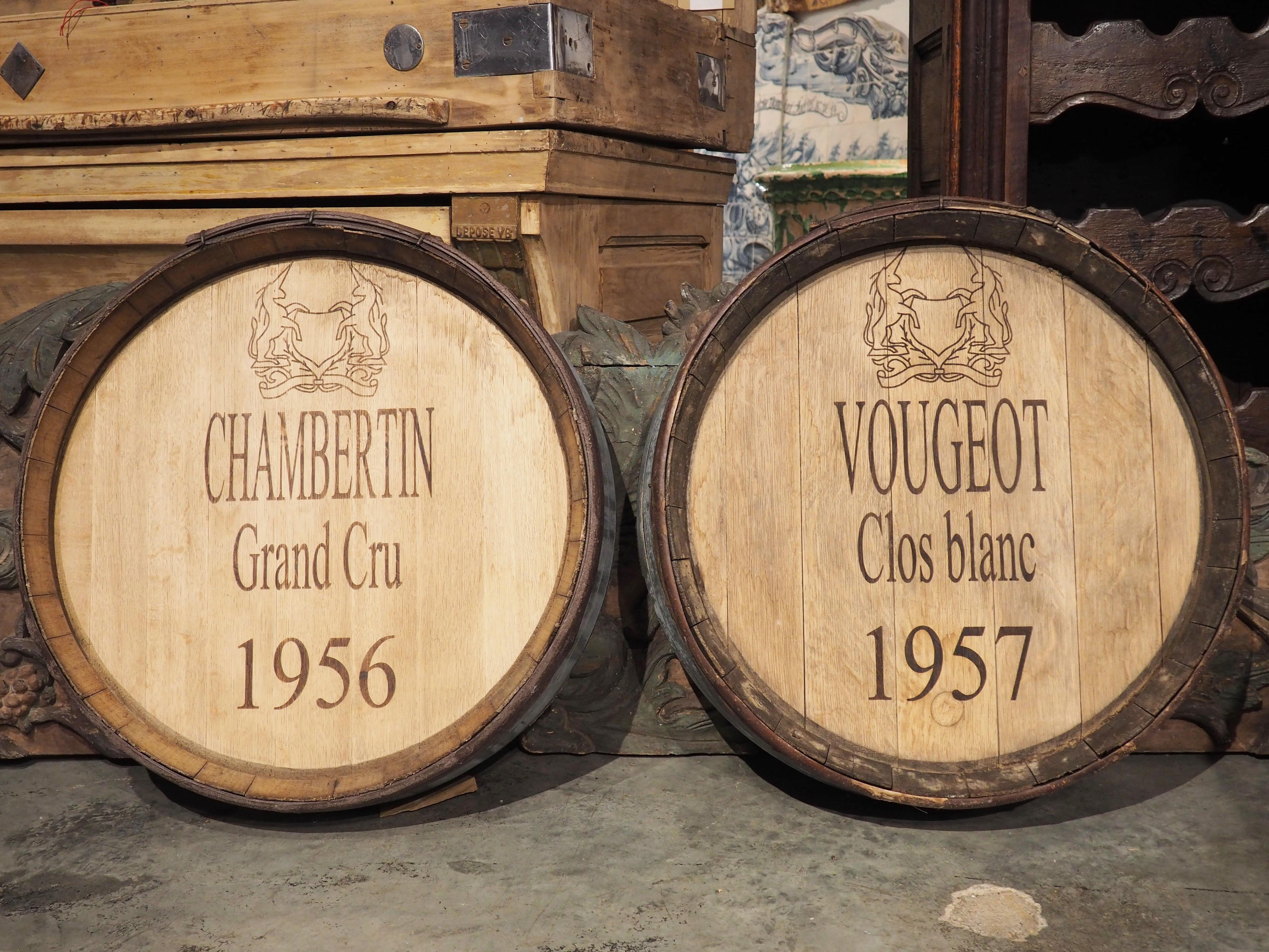 Originally parts of a 20th century French oak wine barrel, this pair of wine barrel heads have been repurposed into facades that are perfect wall-mounted accessories for a bar room. Both facades have been painted more recently with appellations and