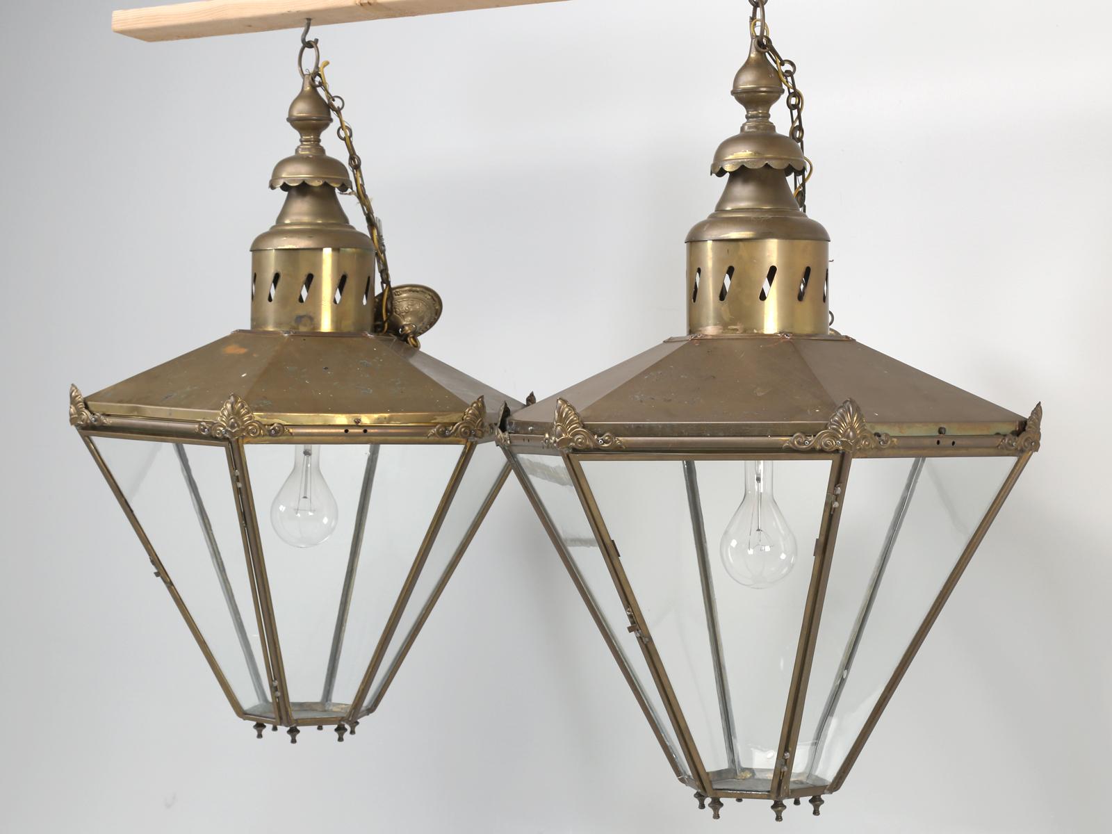 Pair of antique French or English, very large brass lanterns. Although we purchased this pair of antique brass lanterns in France, there is a part of us, that thinks they could have originated in England? What we find most unusual about this pair of