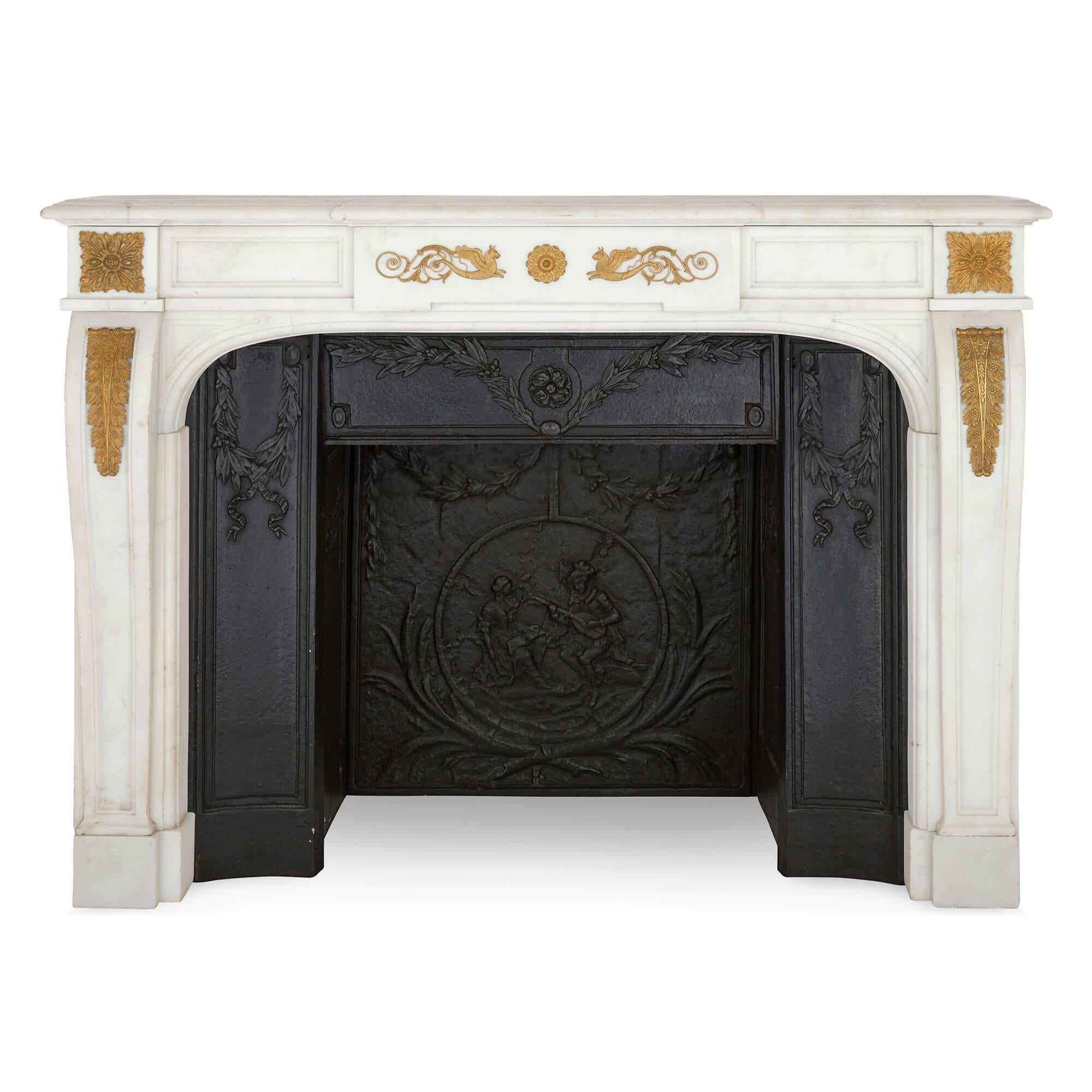 Pair of antique French ormolu mounted marble fireplaces with cast iron insets 
French, Late 19th Century 
Fireplaces: Height 112cm, width 152cm, depth 33cm
Iron inserts: Height 89cm, width 115cm, depth 46cm

Made in late 19th century France from