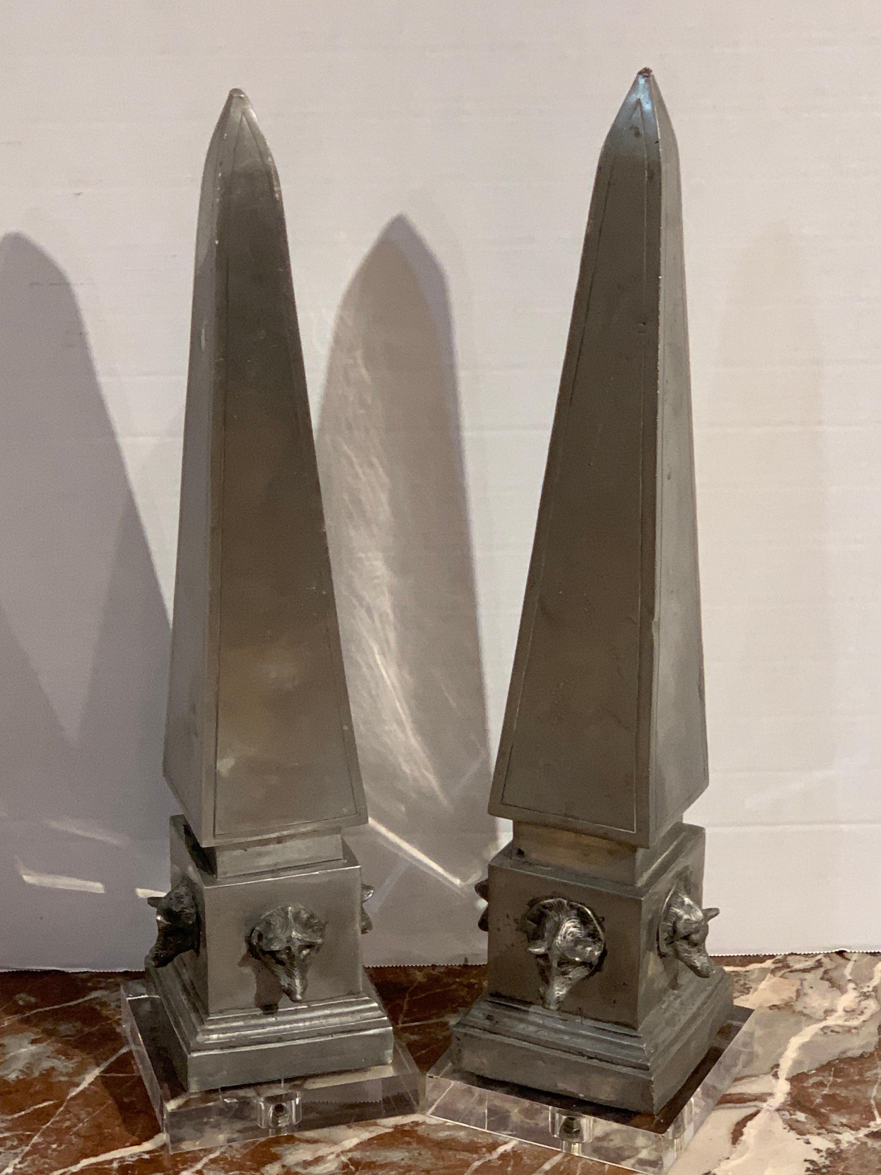 Pair of antique French pewter boars head obelisks, with Lucite bases, each one of typical form with four boars head relief medallions, nicely cast. Mounted on later (removable) 5-inch Lucite bases.
  