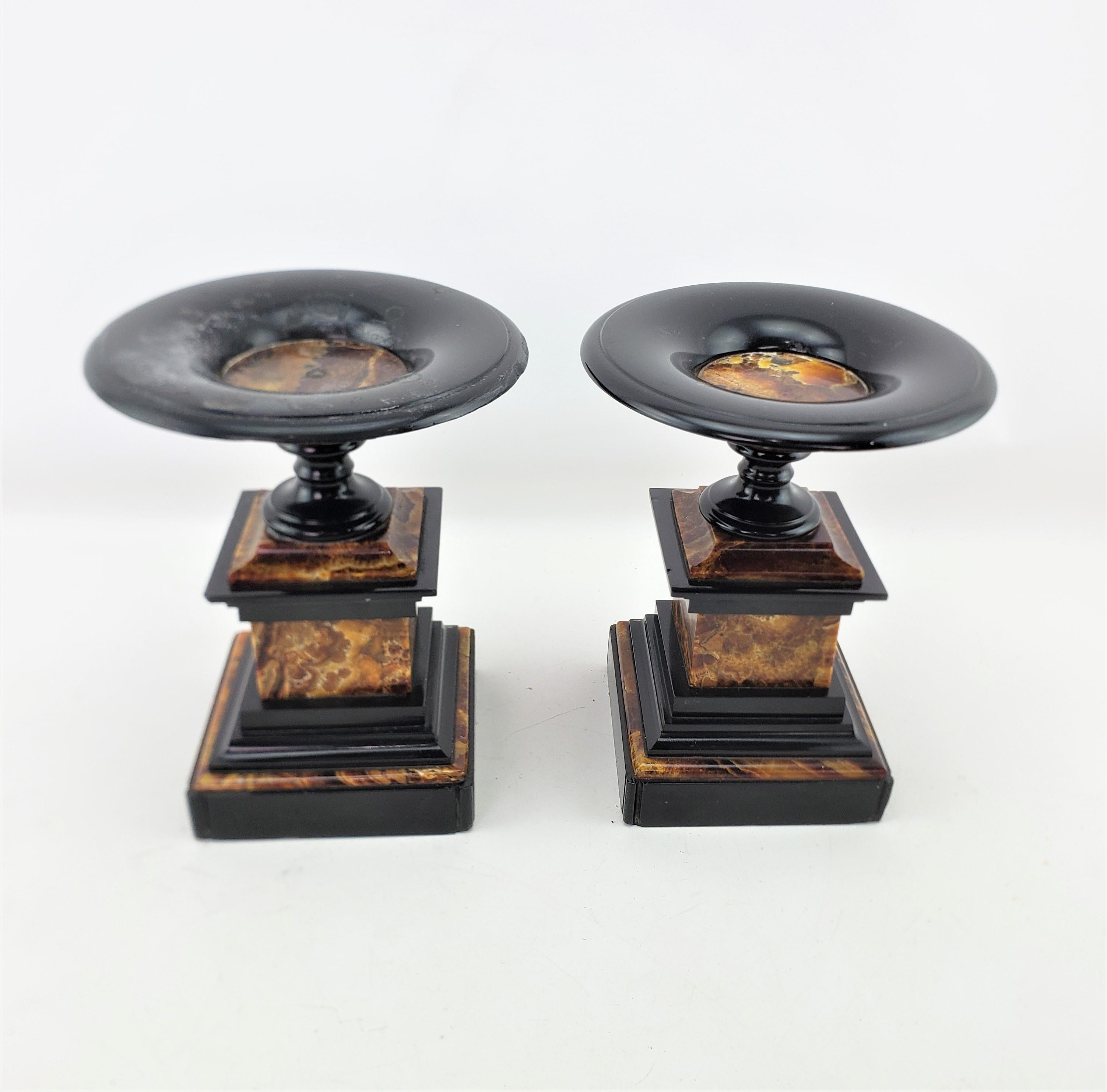 This antique garntirue or tazza set are unsigned, but presumed to have originated from France and date to approximately 1920 and done in an Art Deco style. The set is composed of a very decorative marble with variable colors of browns, orange and