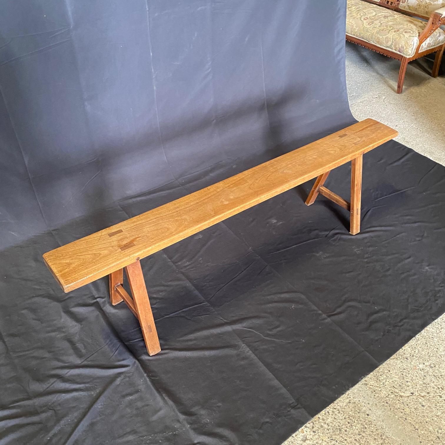 19th century solid wood pair of wooden benches crafted with meticulous attention to detail, having a sturdy wooden construction that ensures durability and longevity. Whether used as dining table benches or standalone seating options, these