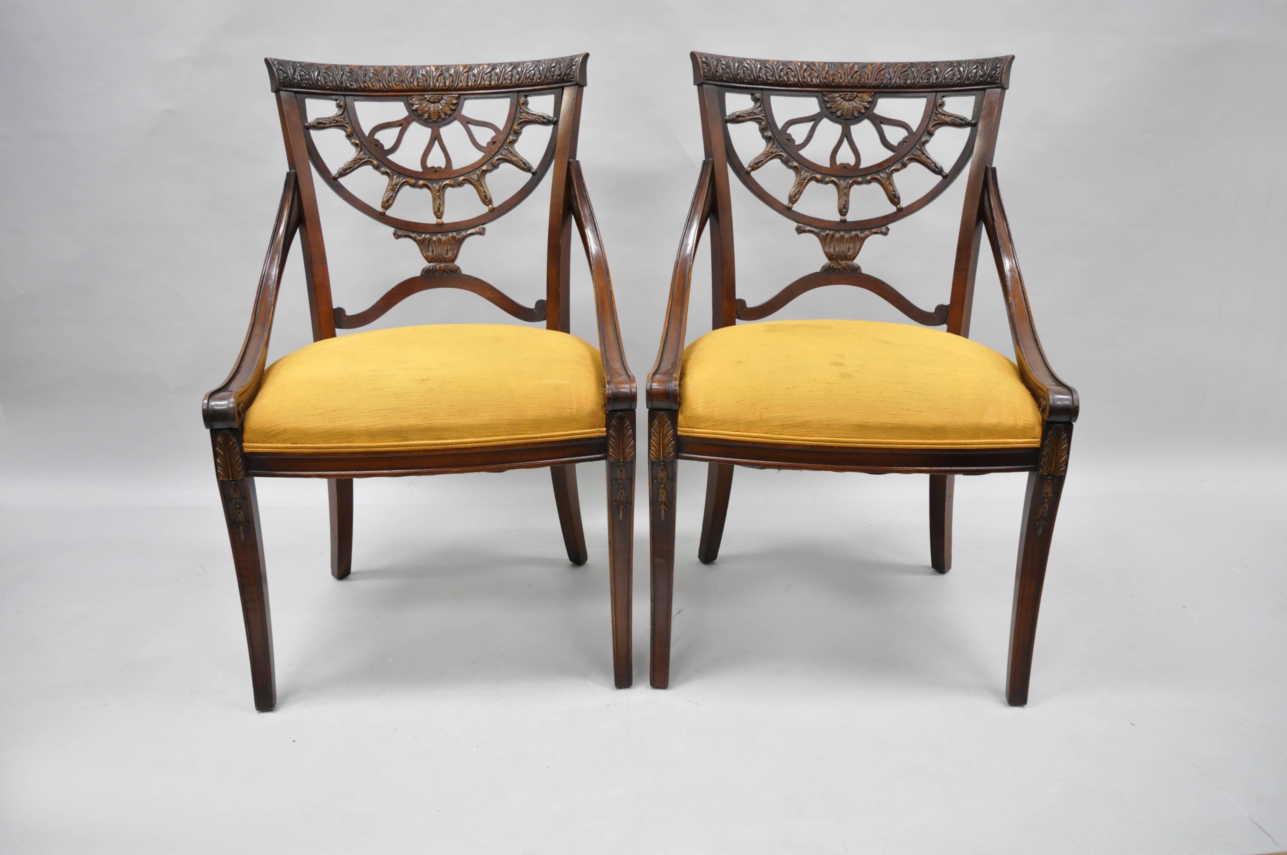 Pair of vintage French regency style mahogany dining room chairs. Item features pierce carved mahogany frames, saber legs, shapely hip rests, elegant regency form.
Measurements: 37