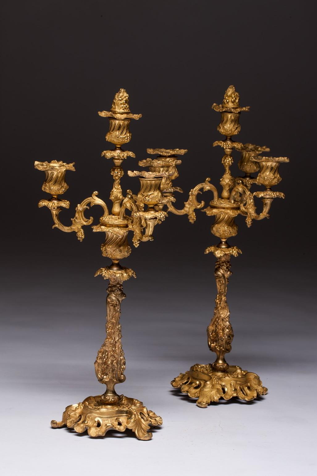 Ornate pair of French Rococo gilt bronze candelabra. Each candelabrum has 4 candle holders. A very decorative item. Late 19th century. Objects in richly gilded and chiseled bronze of fabulous quality. 4 lights candlesticks of great size and impact.