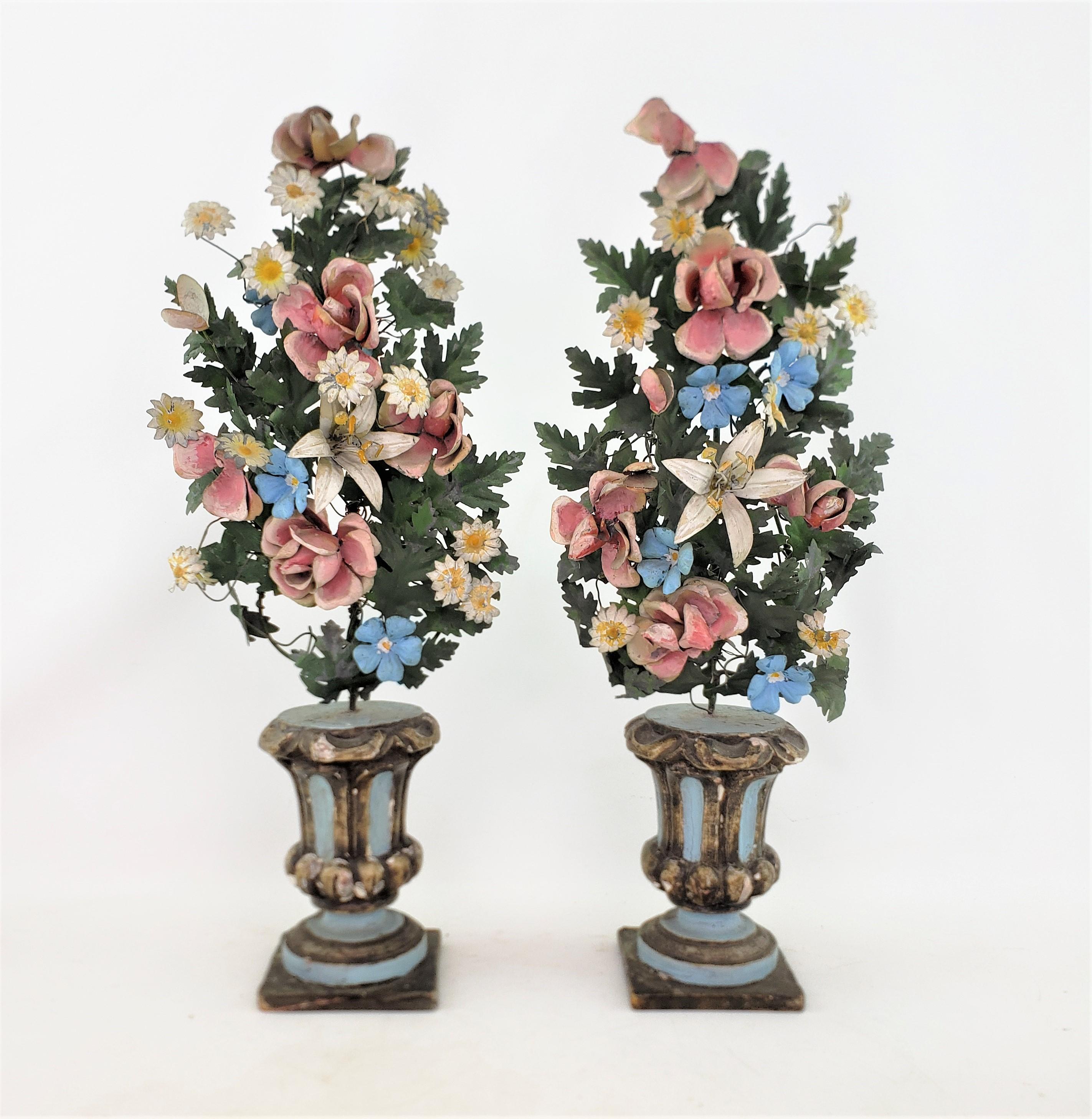This pair of antique toleware bouquet sculptures are branded on the bases by an unknown maker, and date to approximately 1880 and originate from France. The bases are done in pine with a blue pastel painted finish. The bouquets are done with tin and