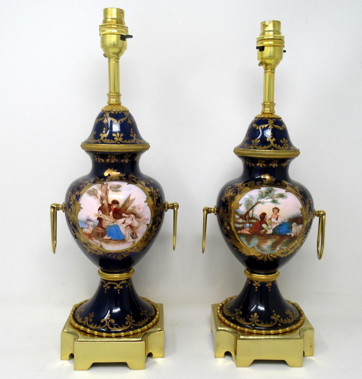 Stunning pair of French Sevres soft paste porcelain and ormolu twin handle electric table lamps of traditional bulbous form and of outstanding quality, and good size proportions, raised on a square stepped heavy gauge ormolu bases with canted