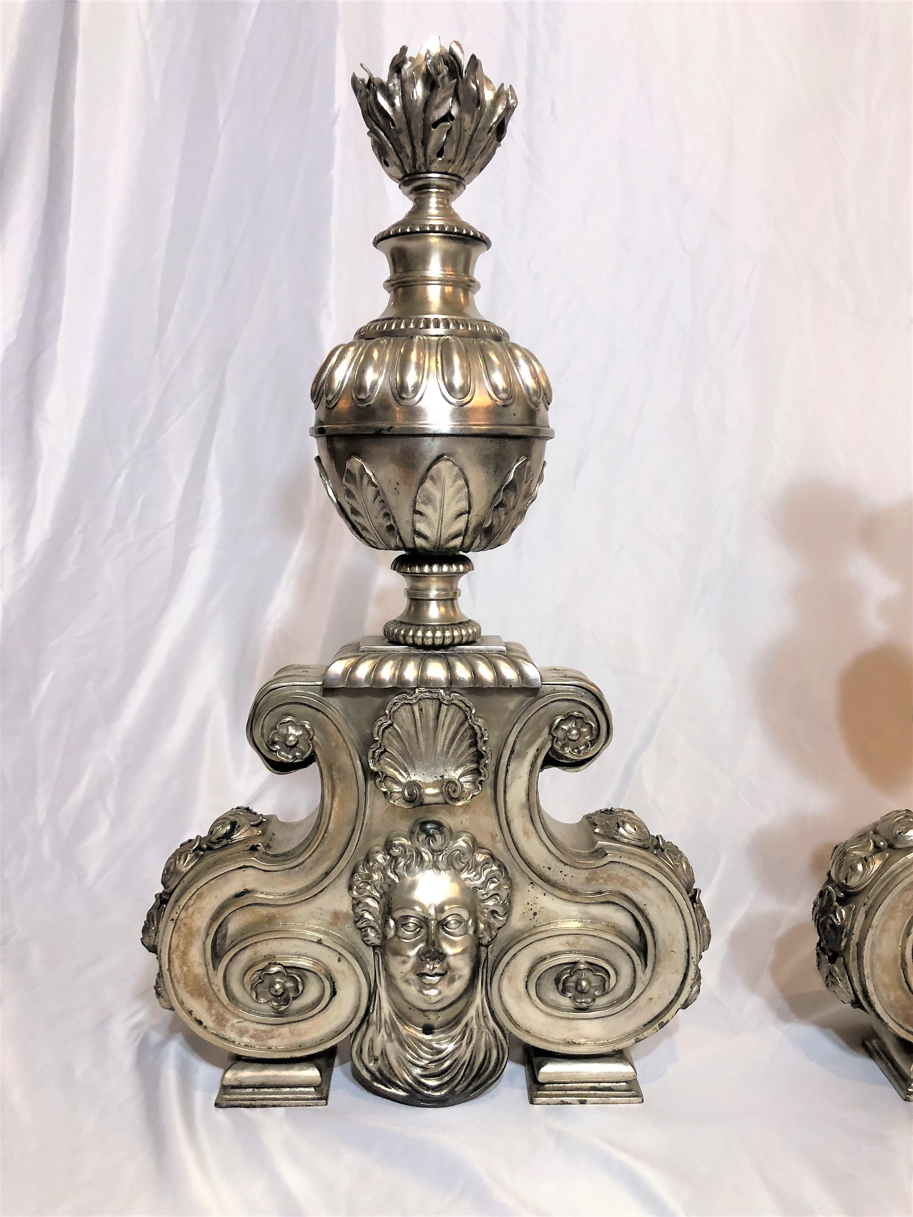 These andirons have been silvered, so they are slightly different than the traditional bronze d'ore ones our shop usually carries. They are handsome and will make a statement in any setting.
