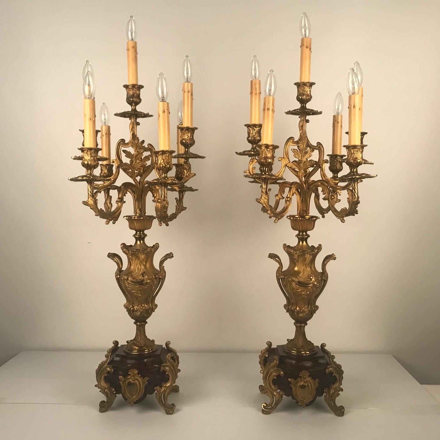 This pair, very much in the Louis XV style, has a number of points of interest : The six arms are arranged around the central light so there are actually seven lights, the vase shaped stem is modelled in bas-relief with leaves, and the base is a