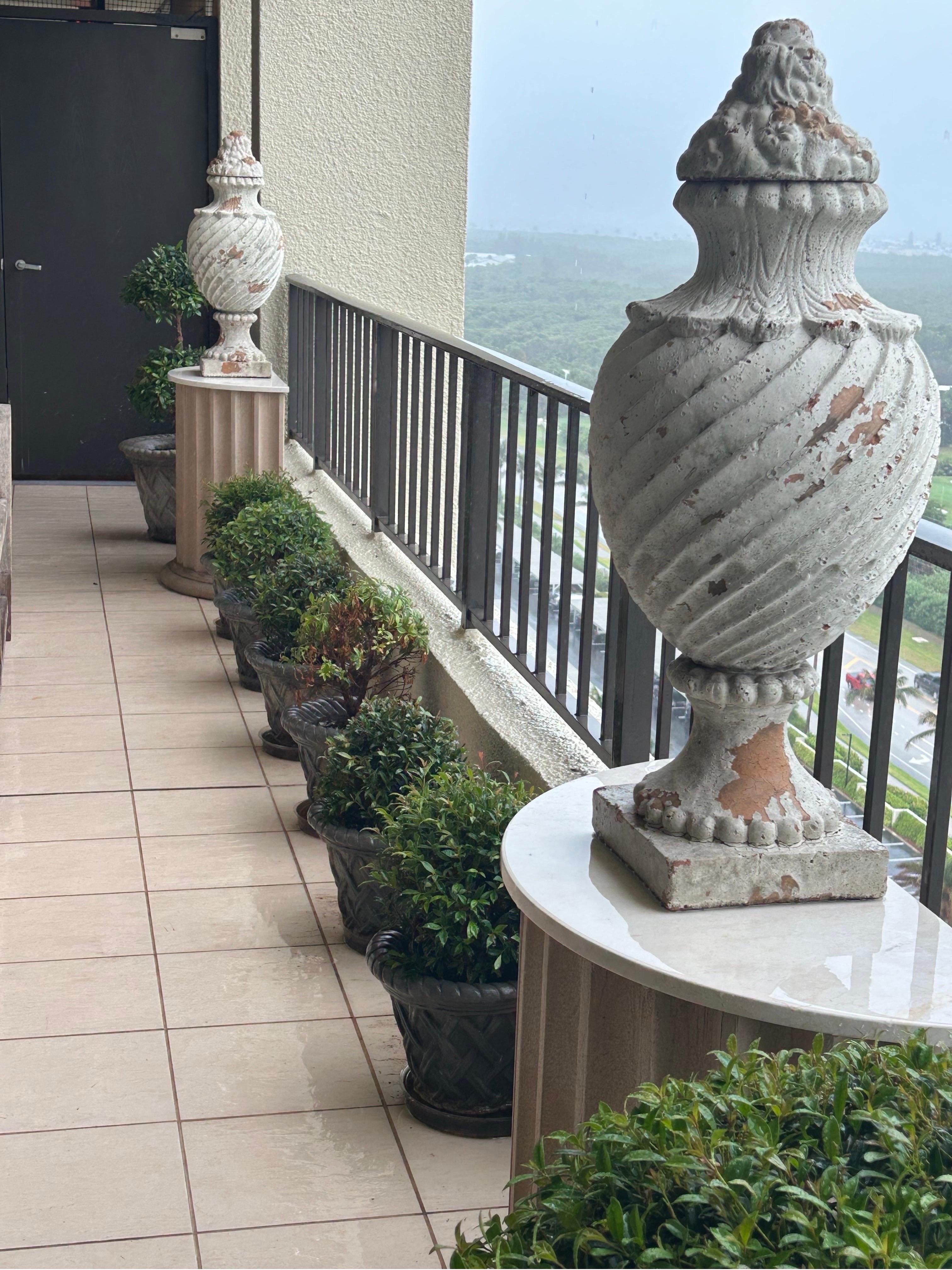 A large pair of Terra-Cotta earns…. France circa 1920… An identical pair is pictured at Wolterton Hall ..the estate of Keith Day and Peter Shepherd in Norfolk UK. in very good condition and measure 32” tall by 13” diameter on 8.5” x8.5” base.. The