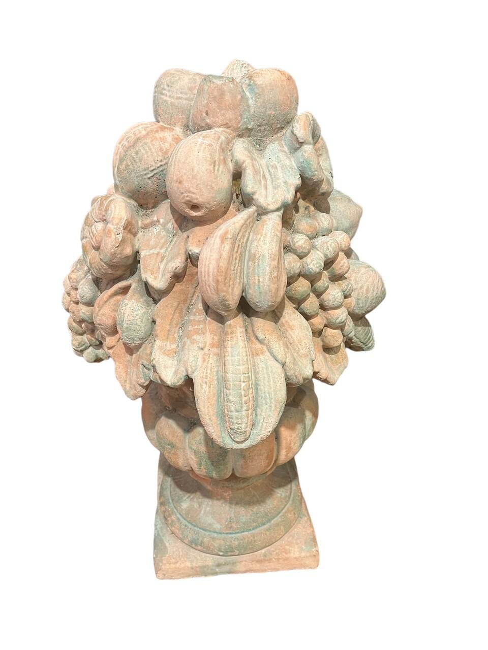A pair of antique French terracotta fruit topiaries, each adorned with clusters of grapes, pears, bananas, and corn, elegantly displayed in urns. These pieces exhibit a lovely patina, speaking to their age and history. Perfect for adding a touch of