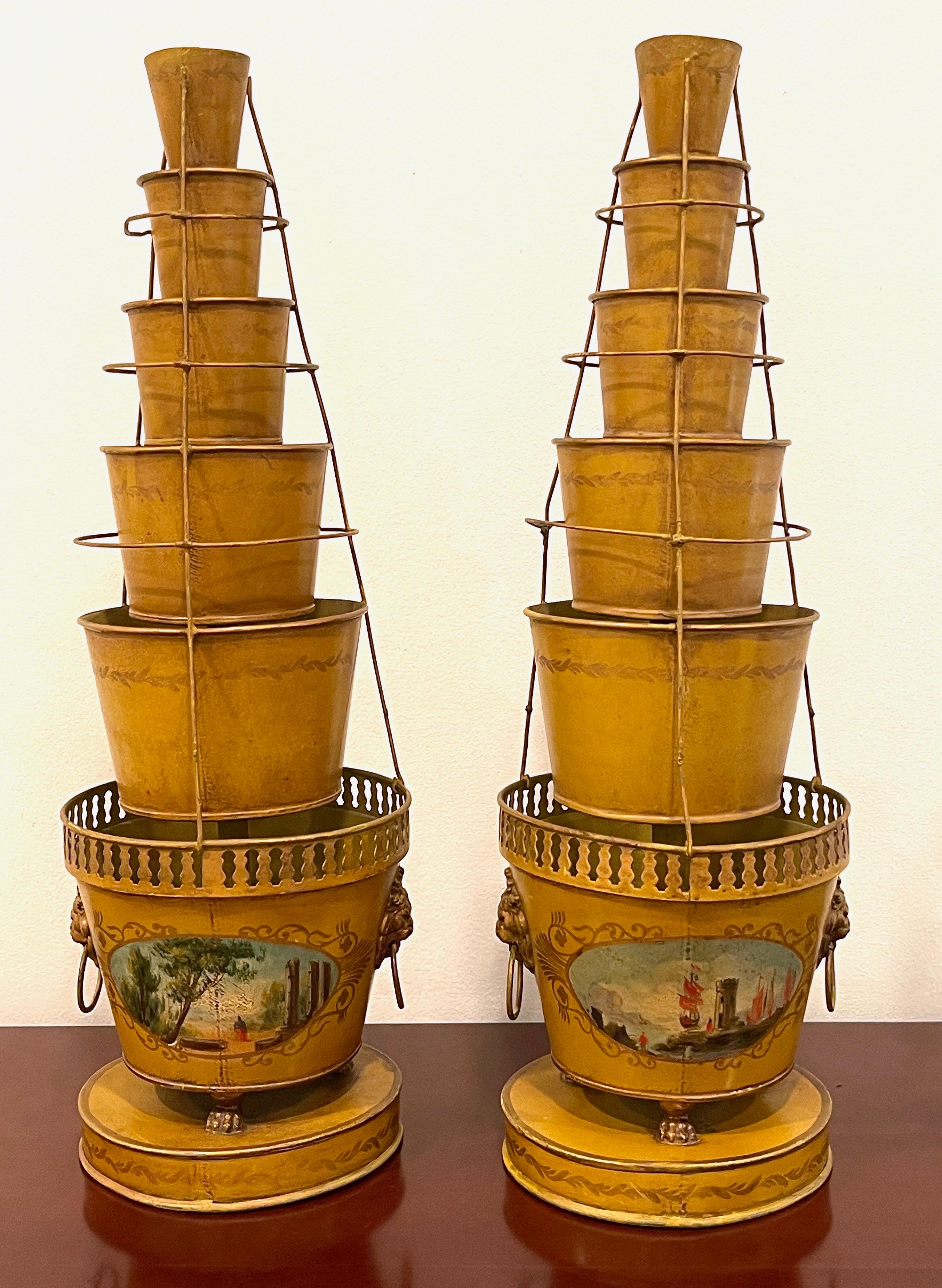 Pair of Antique French Tole Neoclassical Cachepots/Tulipieres
France, Circa 1920

A rare form, each one of obelisk form comprised of six tapering polychromed ochre and gilt background, individual buckets, with wire flower holders. The bottom one