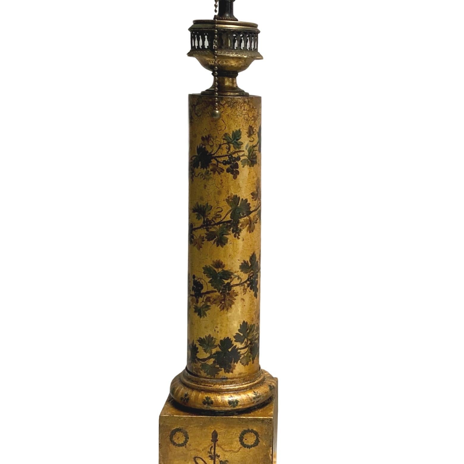 Pair of French circa 1920s gilt and painted tole lamps with foliage motif on a neoclassic column body.

Measurements:
Height of body: 19.5