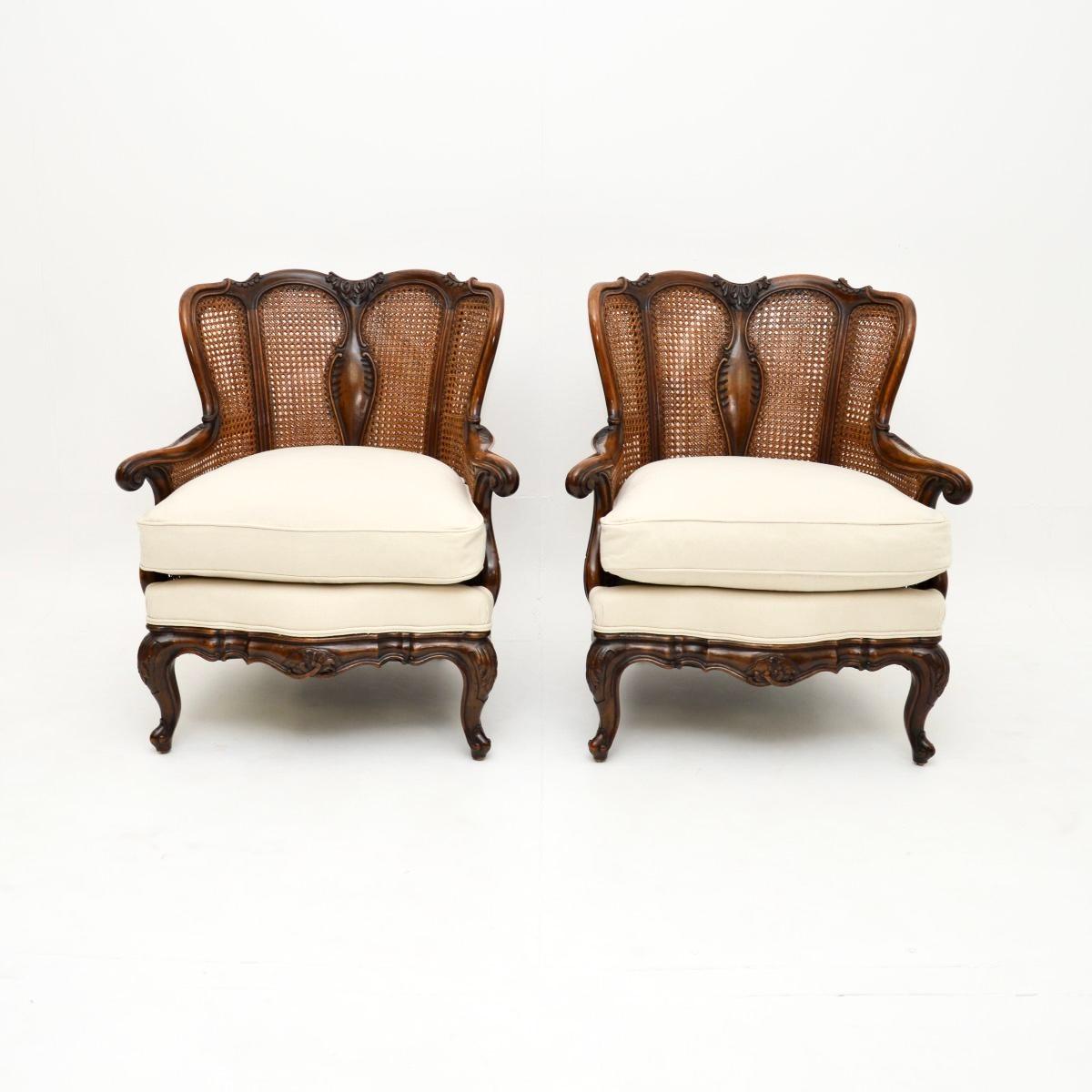 A stunning pair of antique French walnut bergère armchairs. They were made in France, they date from around the 1900-1910 period.

They are of outstanding quality, with amazing carving and beautiful walnut grain patterns. They are a lovely size and