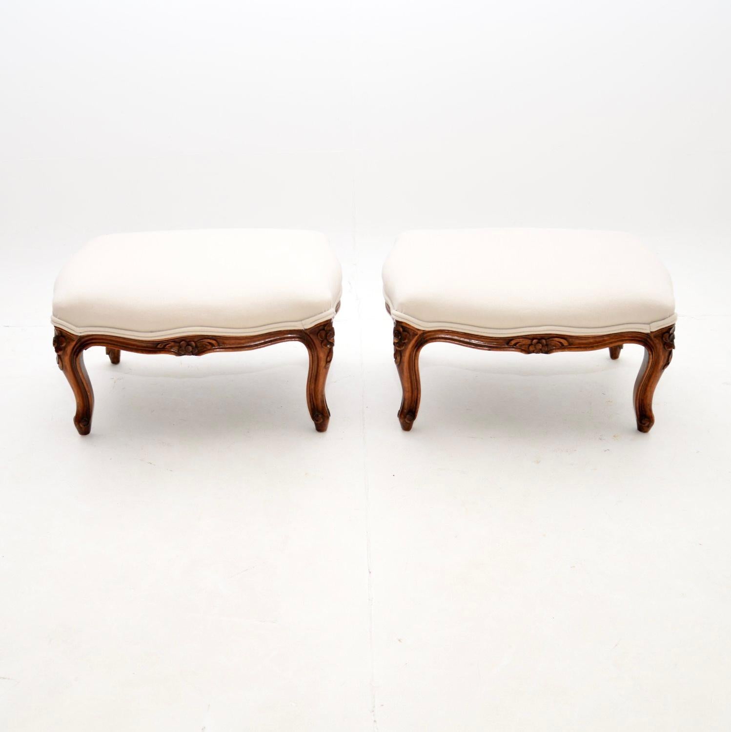 A beautiful pair of antique French walnut foot stools. They were made in France, and date from around the 1930’s.

The quality is superb, the solid walnut frames have beautiful floral carving, with cabriole shaped legs and serpentine edges.

We have