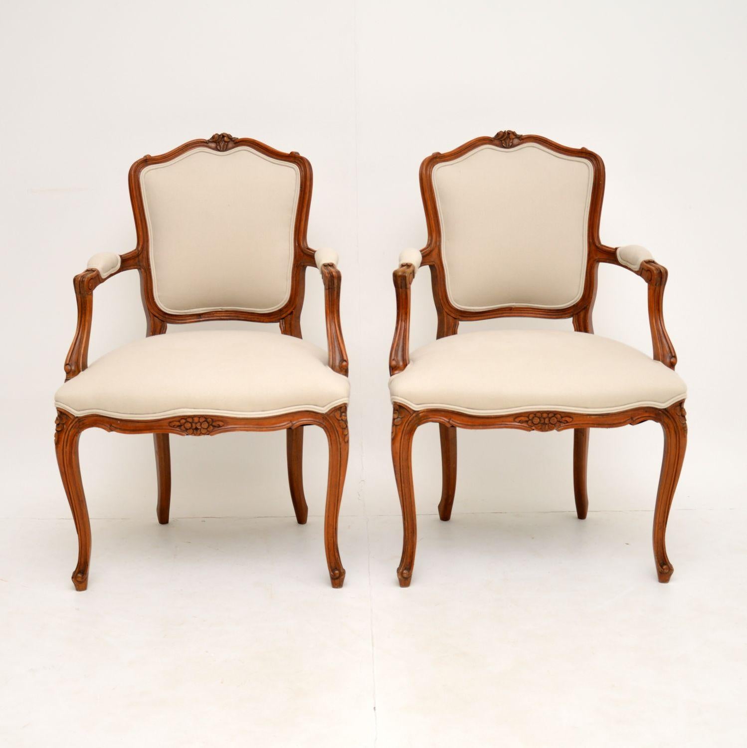 A beautiful pair of antique French salon armchairs, these date from around the 1920’s.

They are of excellent quality, and are made from solid walnut, with some intricate floral carvings around the frames. They are comfortable, sturdy and sound,