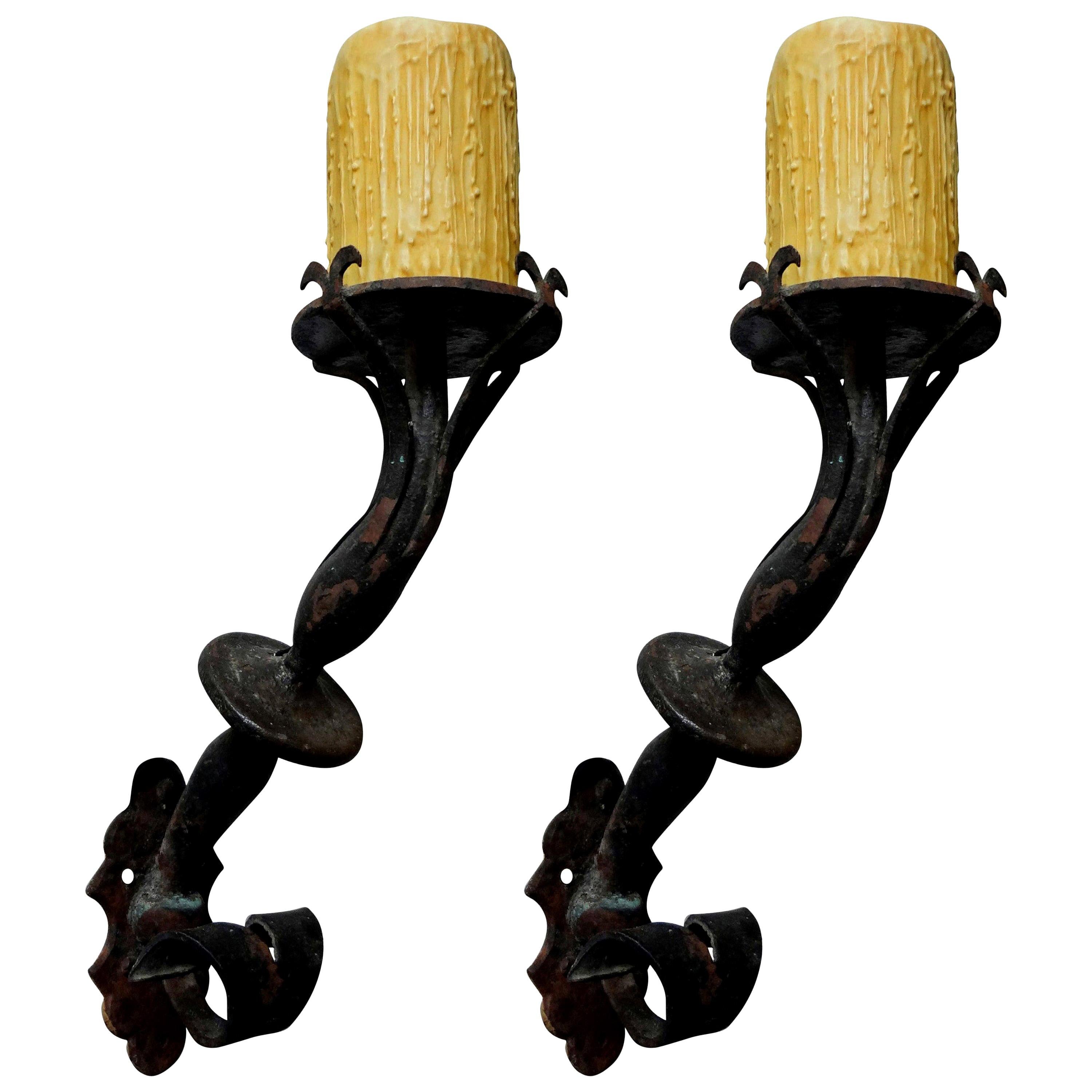 Handsome pair of French hand forged wrought iron torch form sconces, newly wired for U.S. market with new candle sleeves. These Renaissance style or Gothic style sconces are perfect for a French, Italian or Mediterranean home.


  