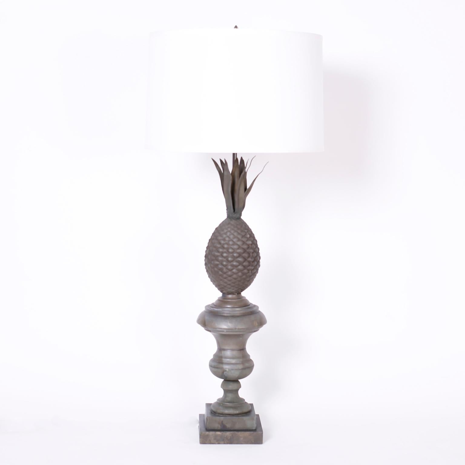 Antique pair of French table lamps crafted in zinc with a pineapple motif and a classical urn form on a double plinth base.