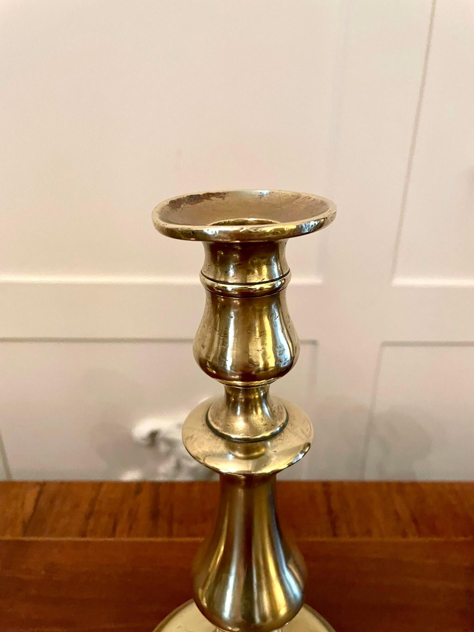 Pair of antique George lII brass candlesticks having a shaped column raised on a round stepped base

Measures: H 24.5cm
W 11cm
D 11cm
Date 1810.
 