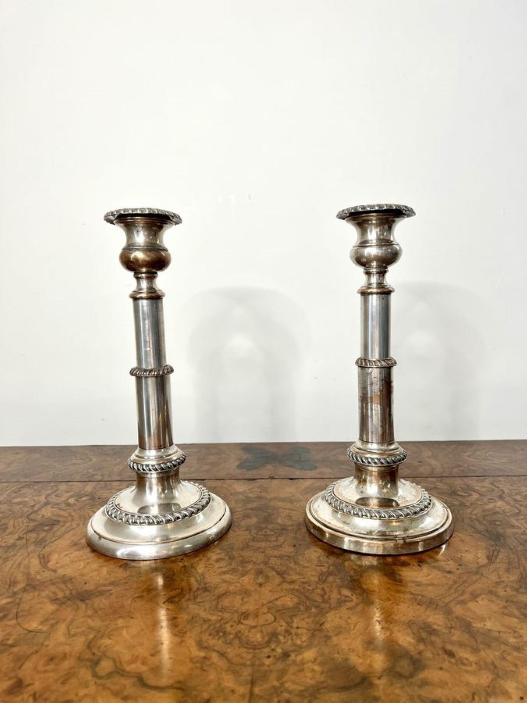 Pair of antique George III telescopic candlesticks having a quality pair of antique George III silver plated on copper telescopic candlesticks standing circular stepped bases.

D. 1800