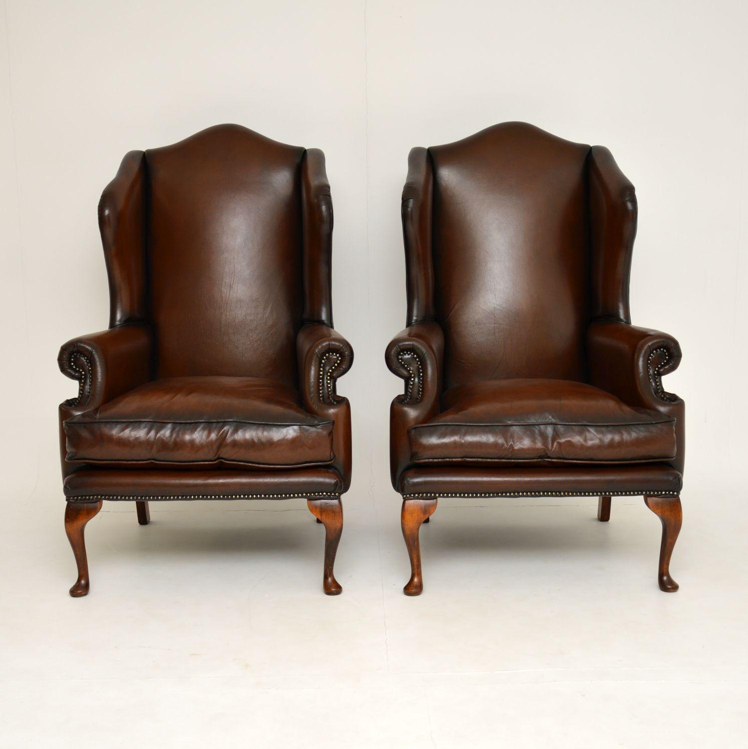 A beautiful and extremely comfortable pair of leather wingback armchairs in the antique Georgian style.

These date from circa 1950s-1960s, they are of excellent quality and have a strong, yet elegant look. They have hump backs, scrolled arms, and