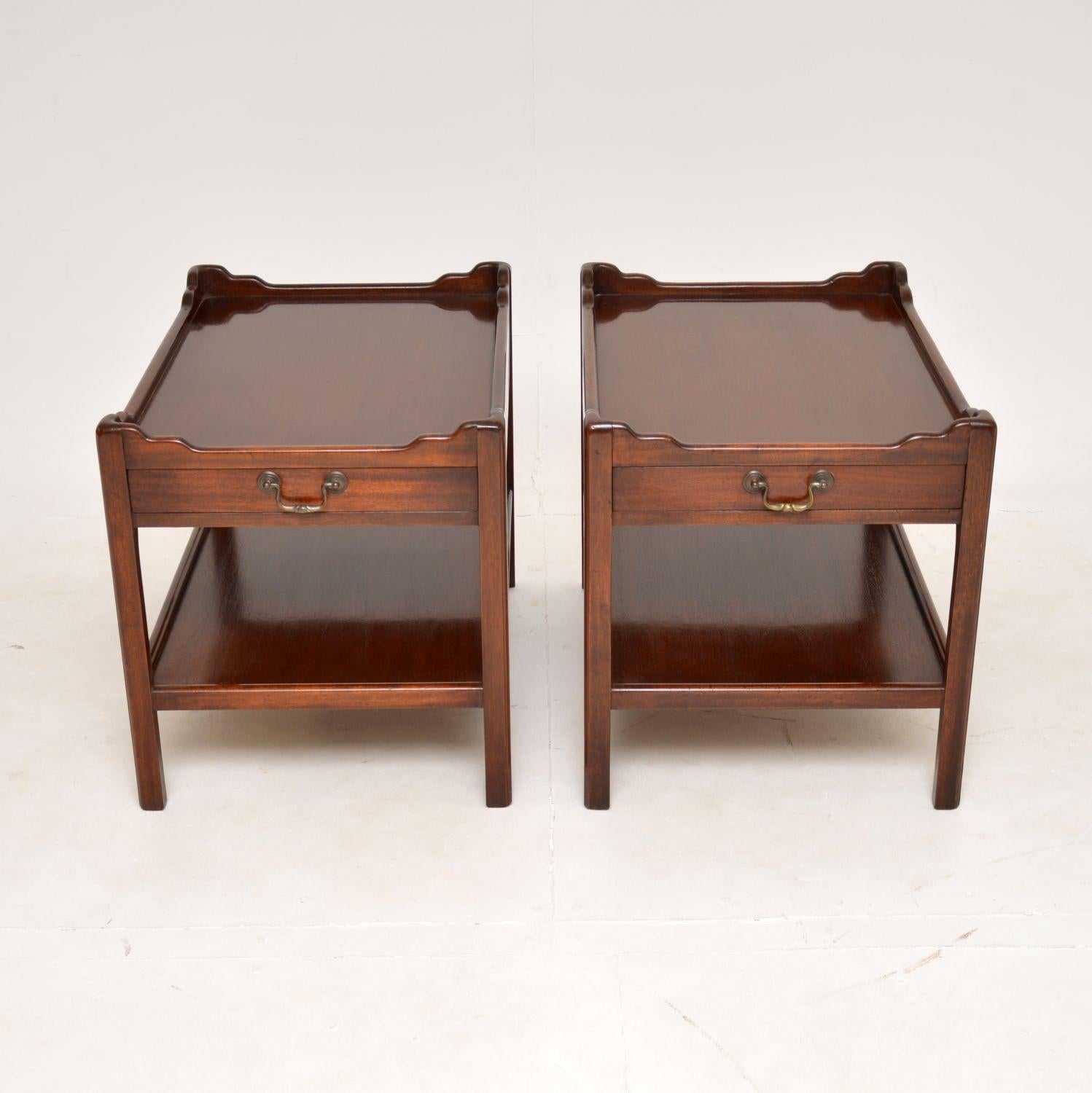A very well made and useful pair of antique wooden side tables in the Georgian style. They were made in England, and date from around the 1950’s.

They are of super quality and have a very practical design. The tops have raised edges with a single