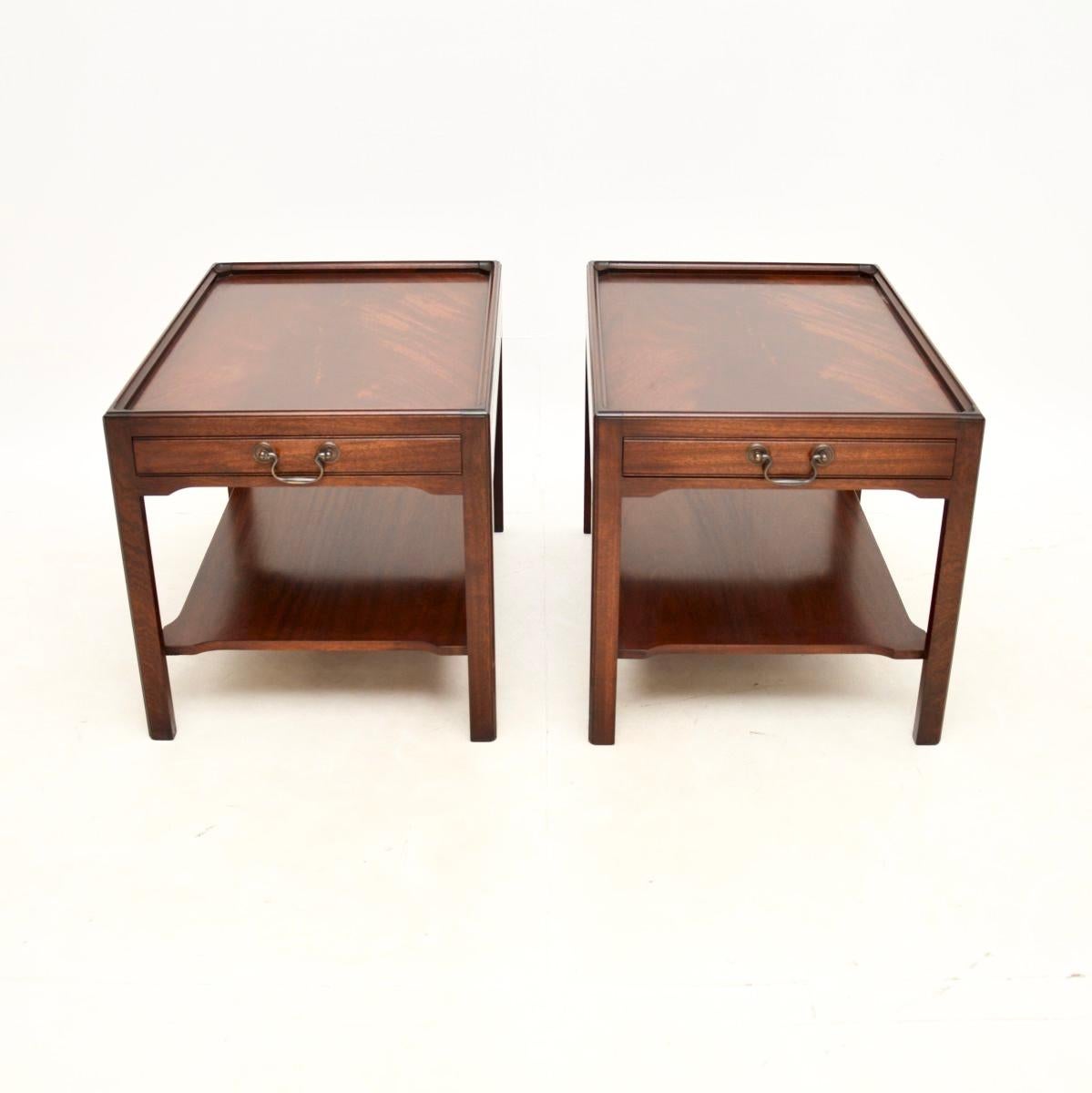 A very well made and useful pair of antique Georgian style side tables. They were made in England, and date from around the 1950’s.

They are of super quality and have a very practical design. The tops have raised edges with a single drawer in each