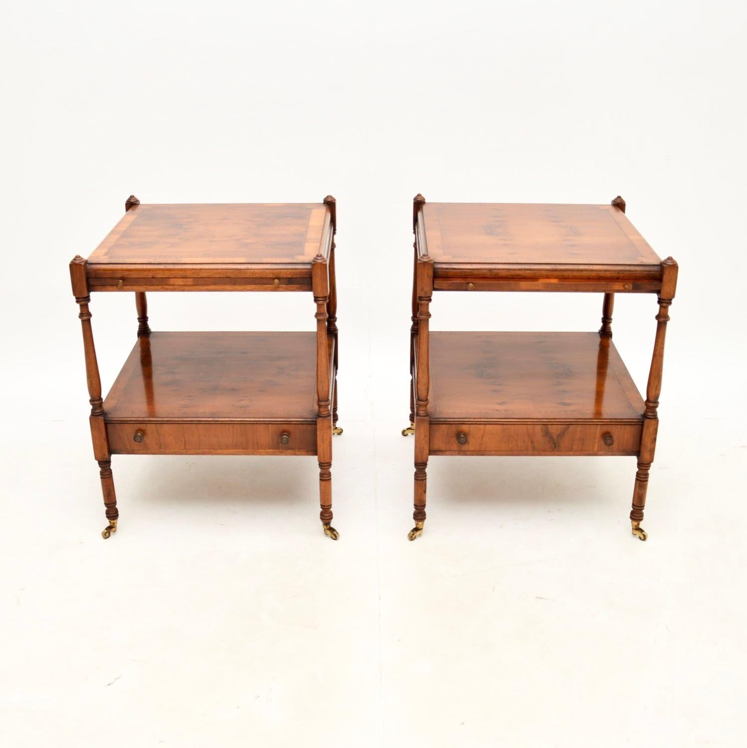 A fantastic pair of antique Georgian style yew wood side tables. They were made in England, and date from around the 1950’s.

The quality is great, they are very well made with beautiful inlays around the borders, nicely turned finials and legs. The