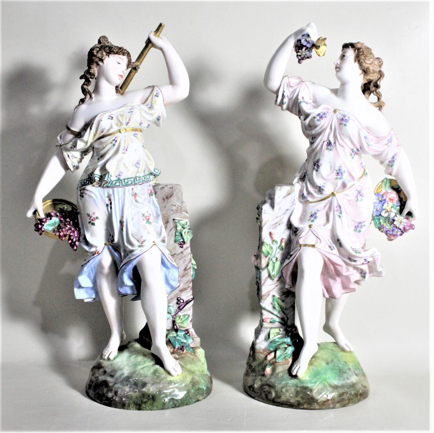 This pair of antique porcelain figurines are marked on their respective bases, but the specific maker cannot be identified. It is presumed this pair of figurines was made in either Germany or Austria in circa 1895 in the period Victorian style. The